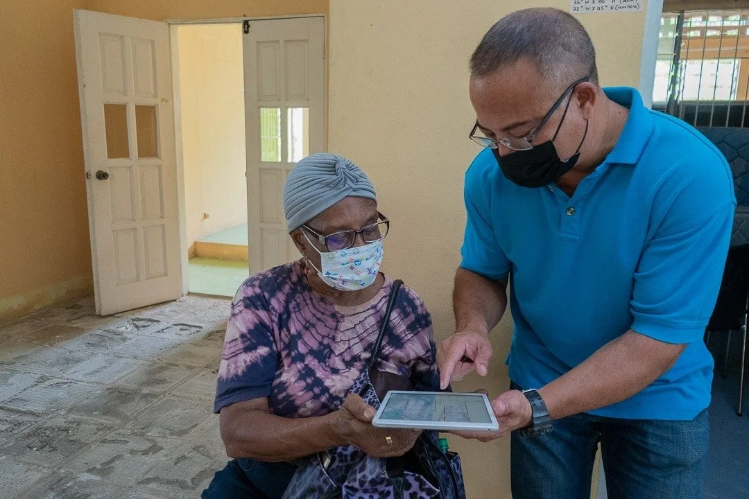  One of the contractors, Russel Aching  (right)  explains an architectural layout to Mizpeh Halfway House Founder, Reverend Pearl Noreiga  (left)  