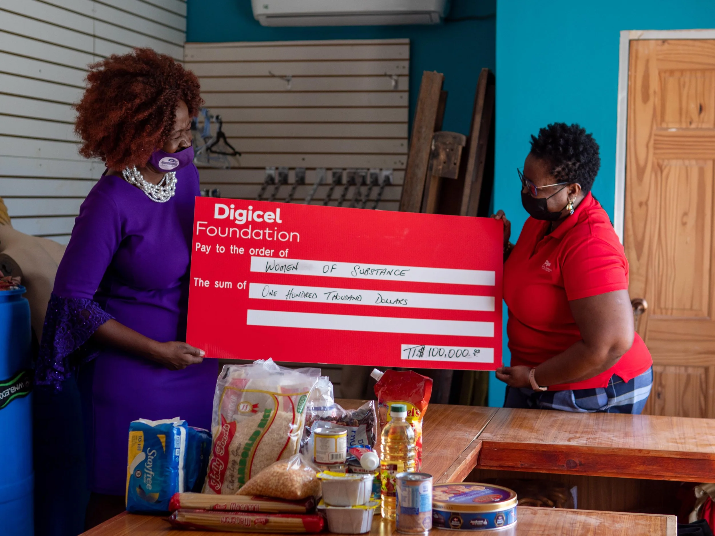   (L-R)  Onika Mars, President and Founder of Women of Substance receives the cheque donation of TTD$100,000 from Digicel Foundation Board Director, Georgina Peterkin which will go towards developing- Shangri-La Empowerment Centre for Women, a safe haven for women who are survivors of domestic violence. 