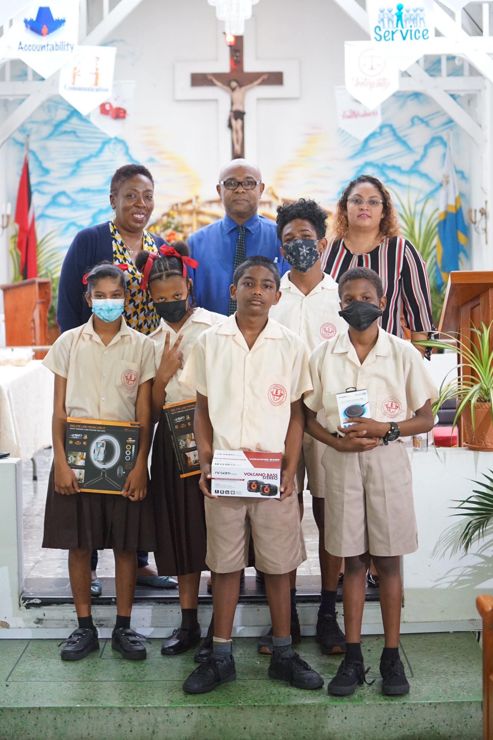 Students from St Christopher’s AC School, Siparia pose for a picture with their various prizes during the prize giving ceremony with (Back L-R) Digicel Foundation Project Consultant Natalie- Anne De Silva, Principal Roger Sirju from St Christopher’s AC School and Digicel Foundation Director Bibi Mohamed-Singh.