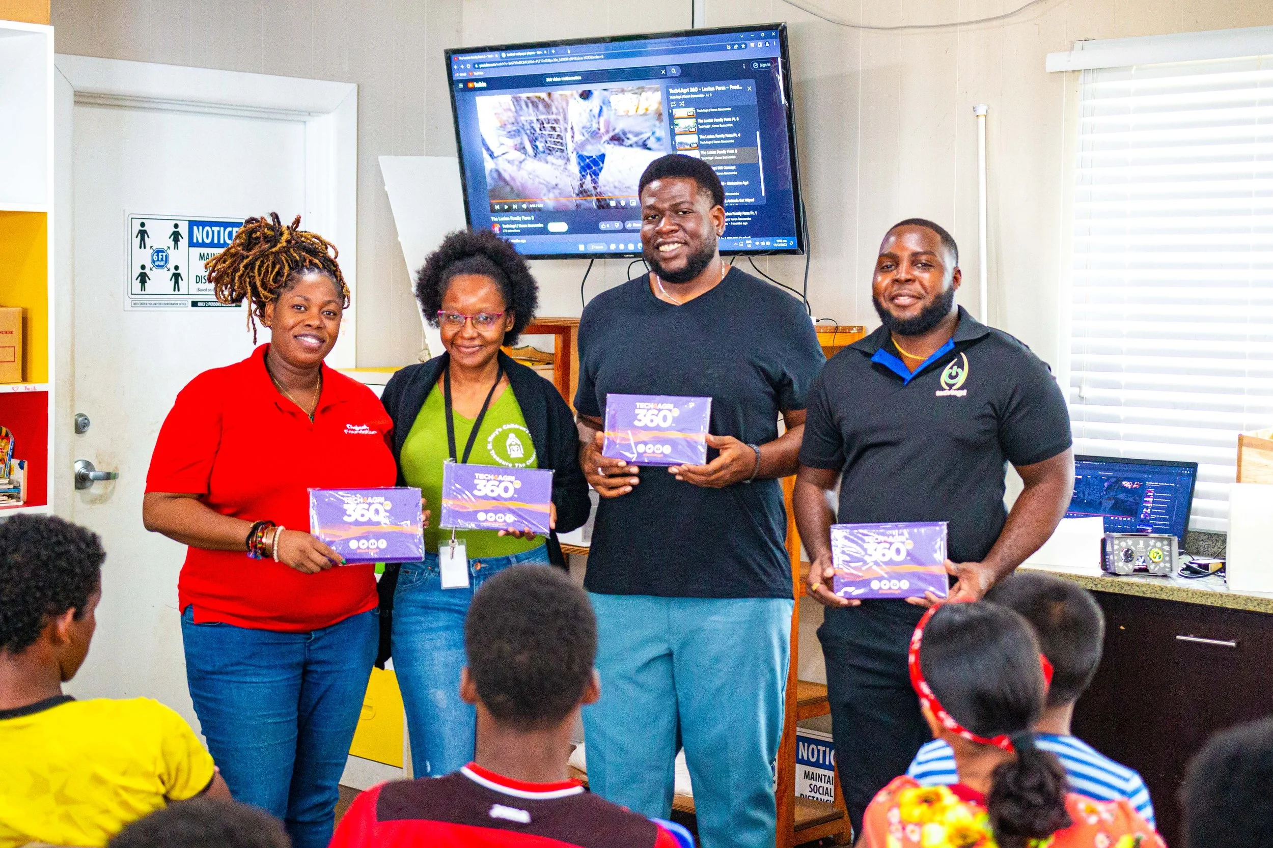 (L-R) Digicel Foundation Operations Manager- Cindyann Currency, Giselle Burton at St Mary’s Children’s Home, Keron Bascombe -Creator Tech4Agri 360 and Deston Pope -Operations Support Tech4Agri display some of the devices.