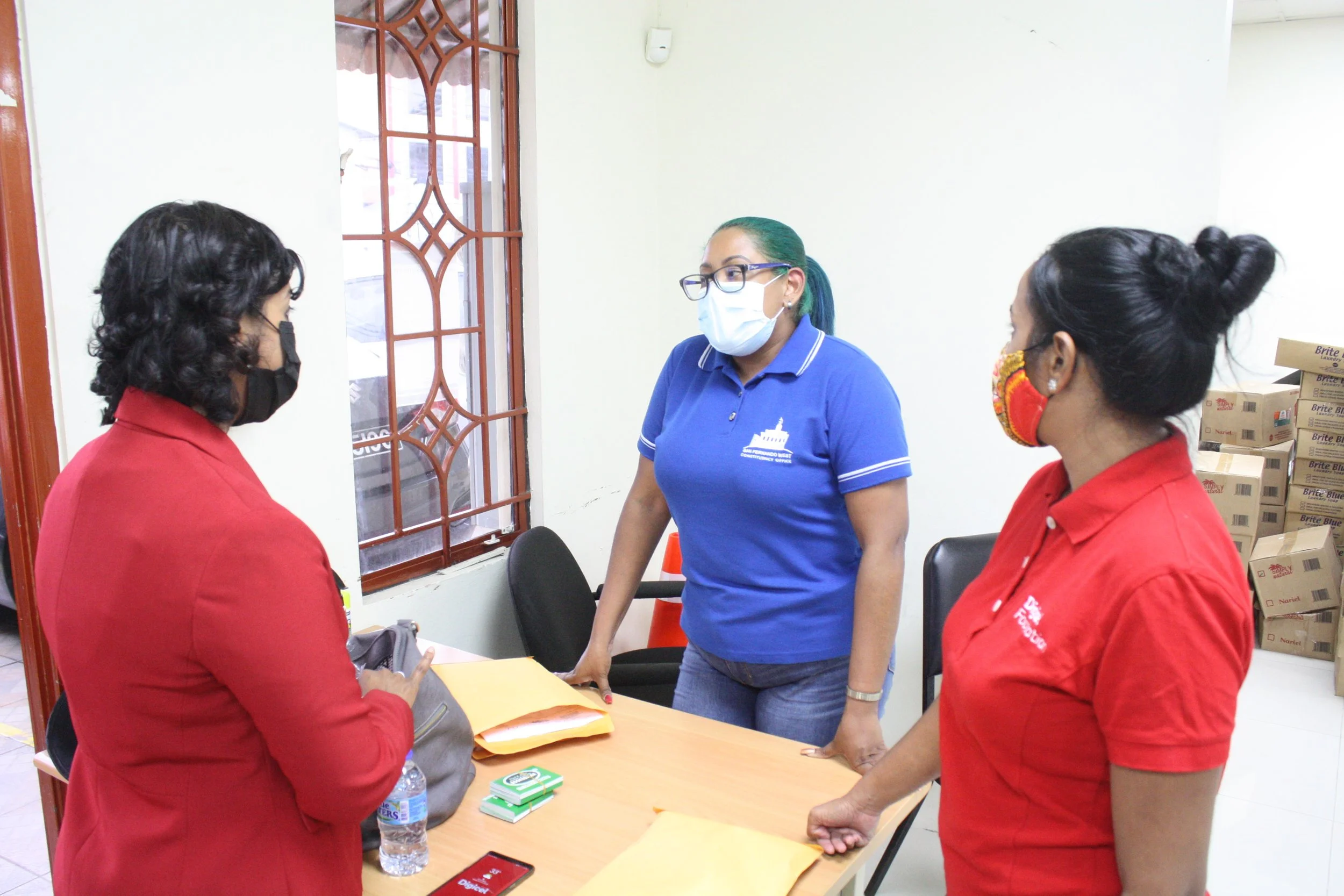  Chairperson of the Digicel Foundation, Mrs Desha Clifford (left) and Digicel Foundation Project Coordinator Diana Mathura-Hobson(right) chats with Alisha Ali, Office Manager, The Office of the Member of Parliament for San Fernando West 