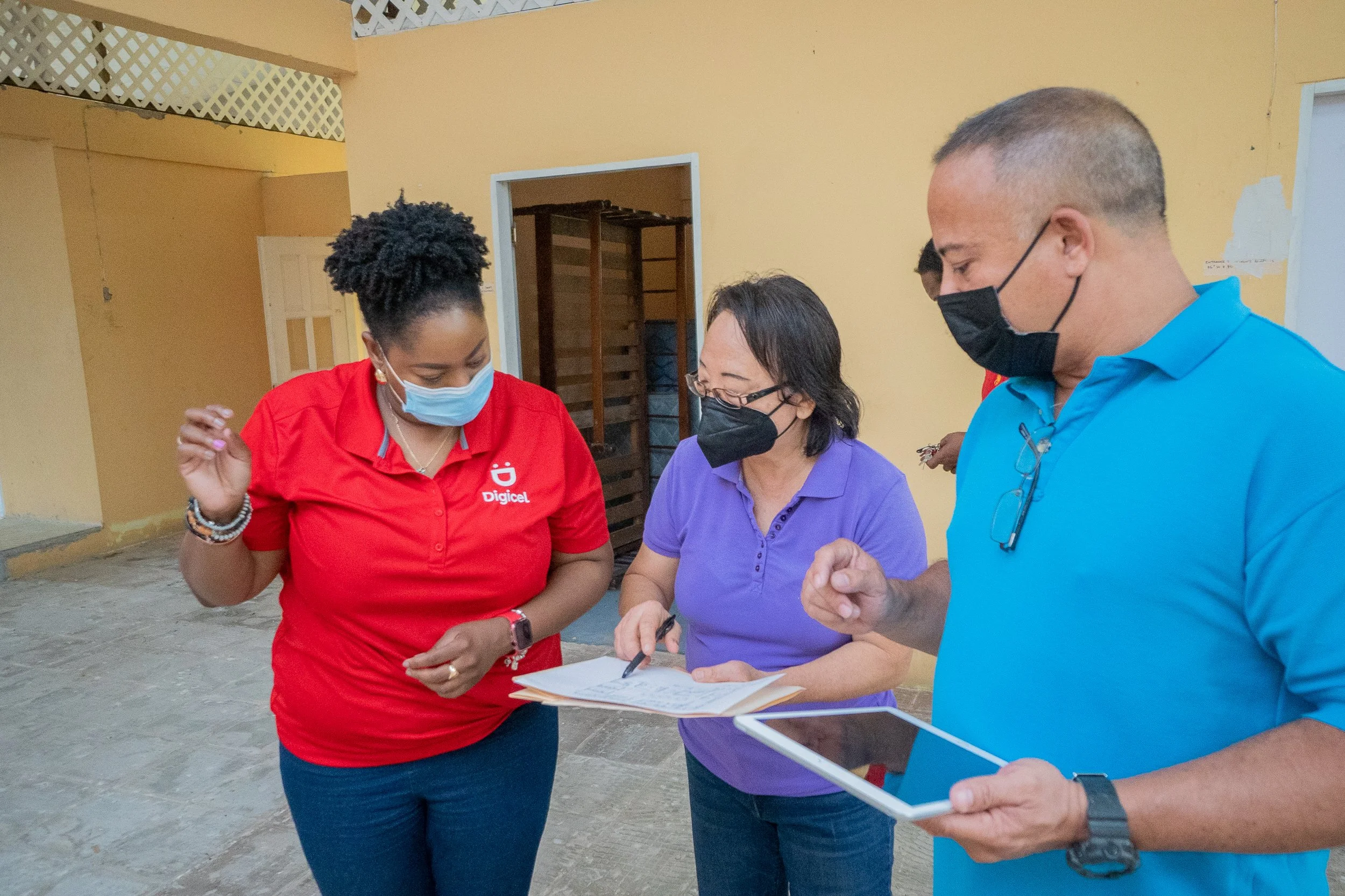  One of the contractors, Russel Aching  (right)  explains an architectural layout to Mizpeh Halfway House Founder, Reverend Pearl Noreiga  (left)  