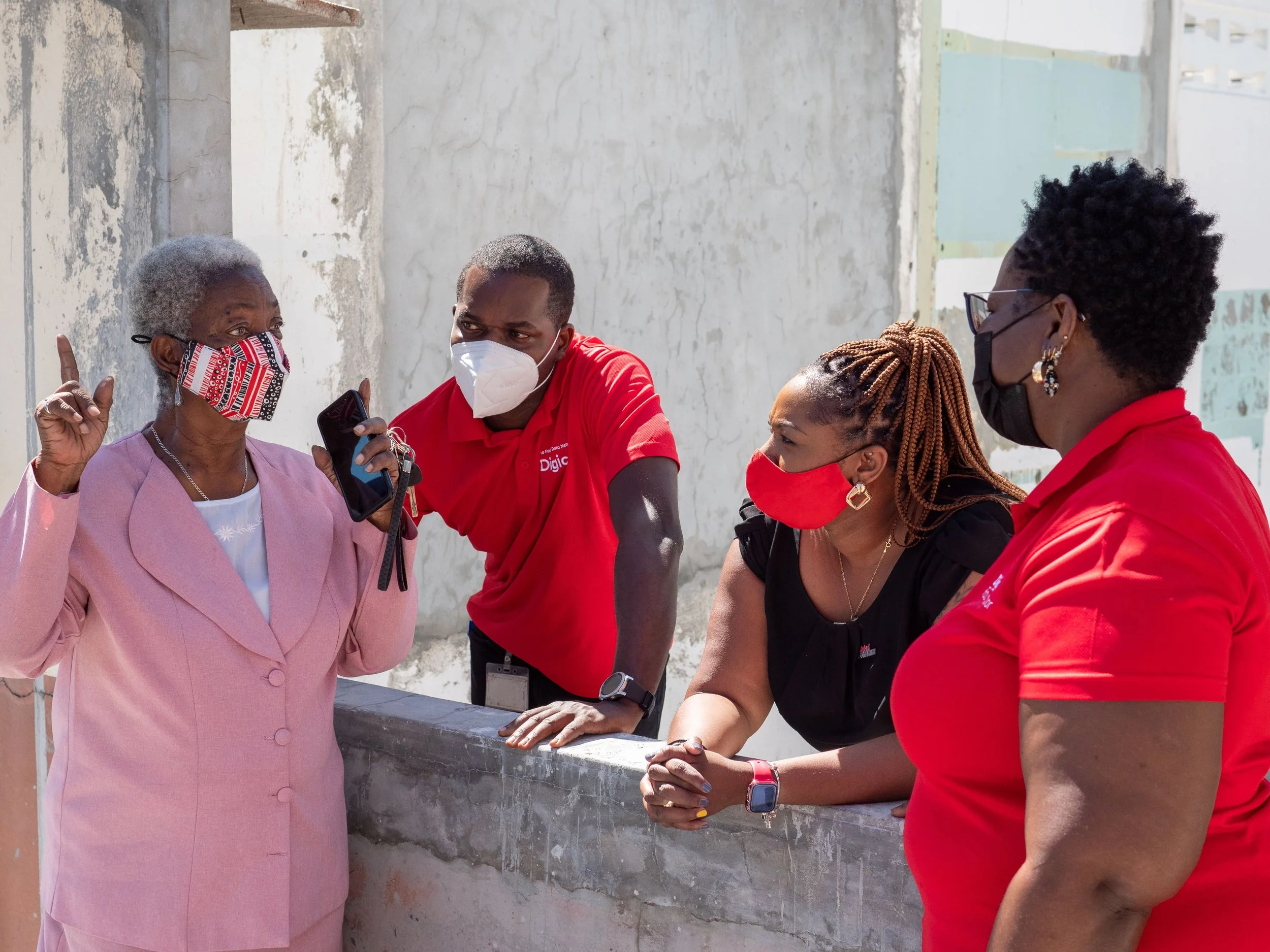   (L-R)  Carmen Charles, Secretary of Pembroke Cultural Stars (TTARP) chats with the Digicel Foundation team. 