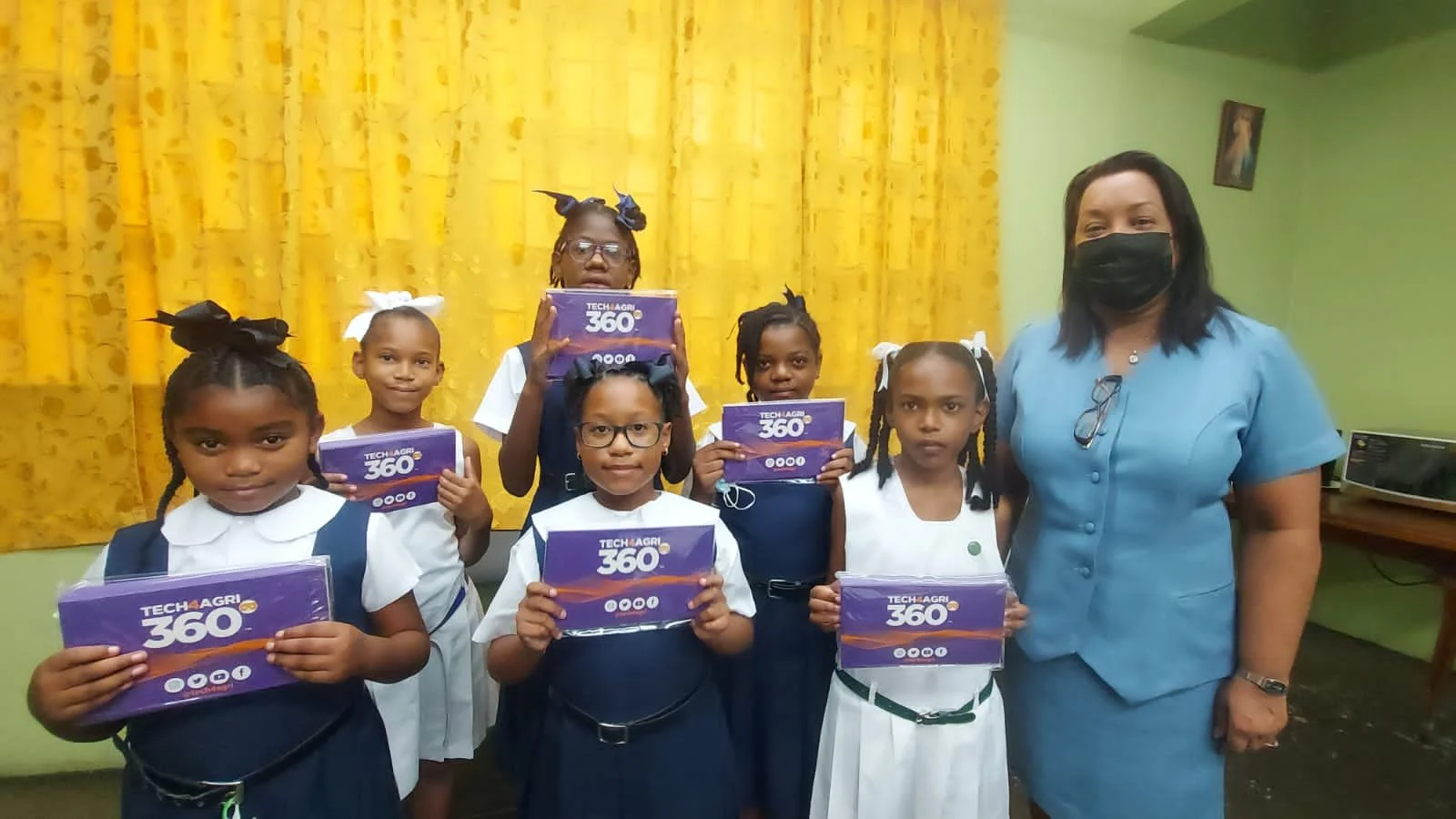 Principal Ms. Yum Young (far right) stands with some of the students from Tunapuna Girls .