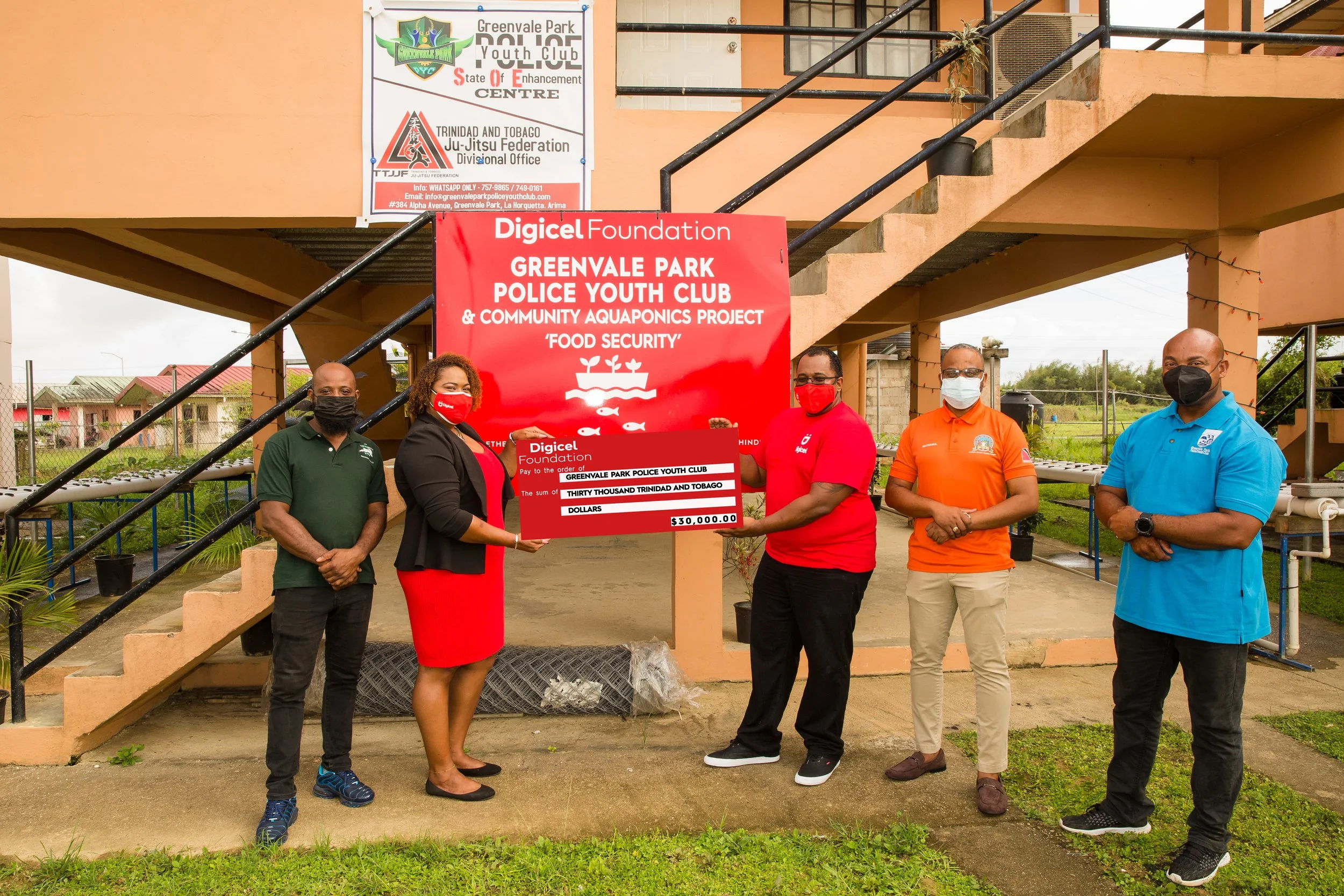   (L-R):  Sean Austin - Greenvale Park Police Youth Club Agripreuner Coordinator, Digicel Foundation Board Director, La Toya Gopaul, Digicel Senior VAS and billing Engineer, John Ramirez, Professor Oluyemi Mashama - Greenvale Park Police Youth Club Assistant Leader. Norman Sorzano - Greenvale Park Police Youth Club President stand for a photo op during the brief cheque presentation ceremony. 