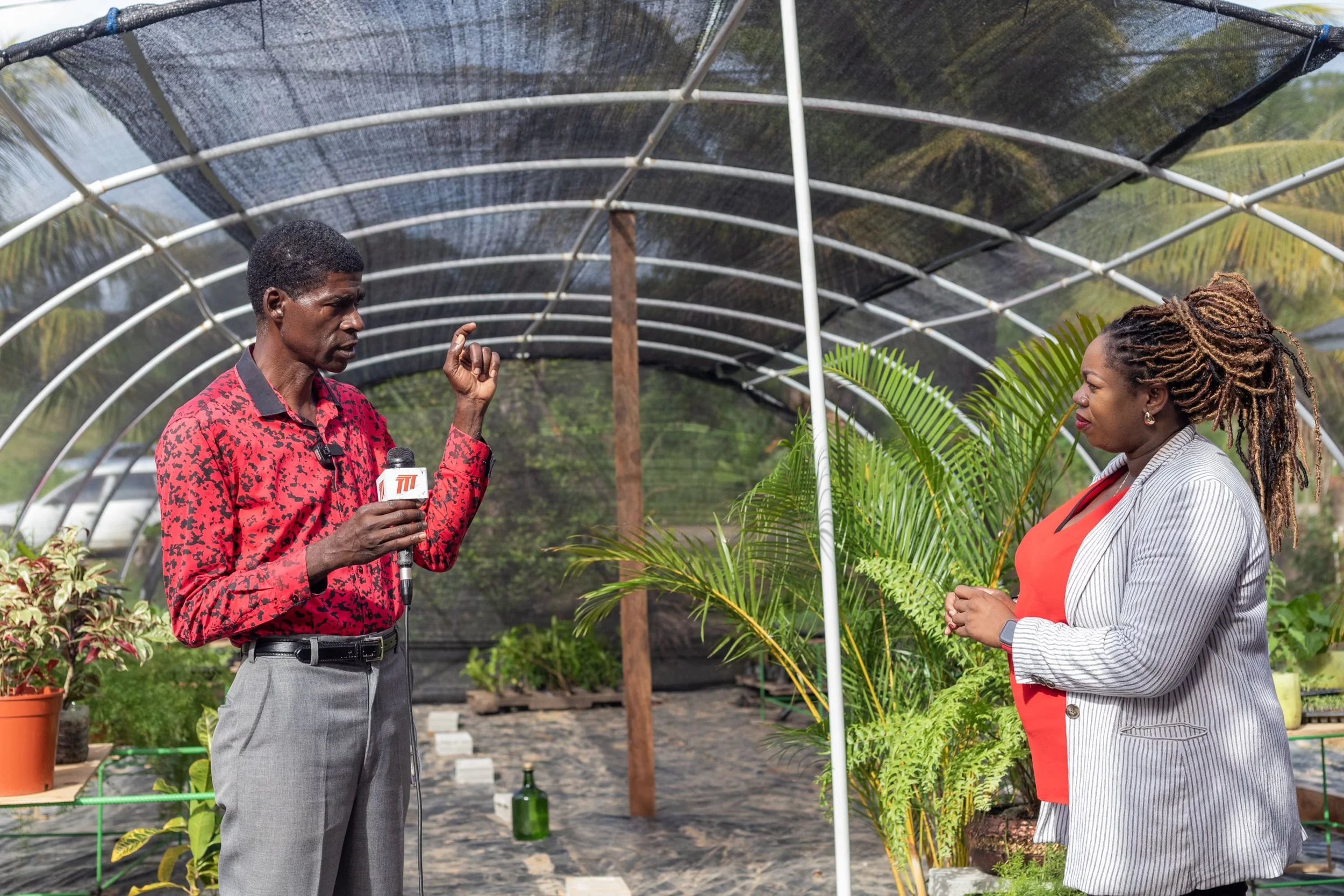   (L-R)  The Moruga 2050 Association for Sustainability President- Francis Paul chats with Digicel Foundation Operation Manager, Cindy Ann Currency for a media interview at the launch of the project. 