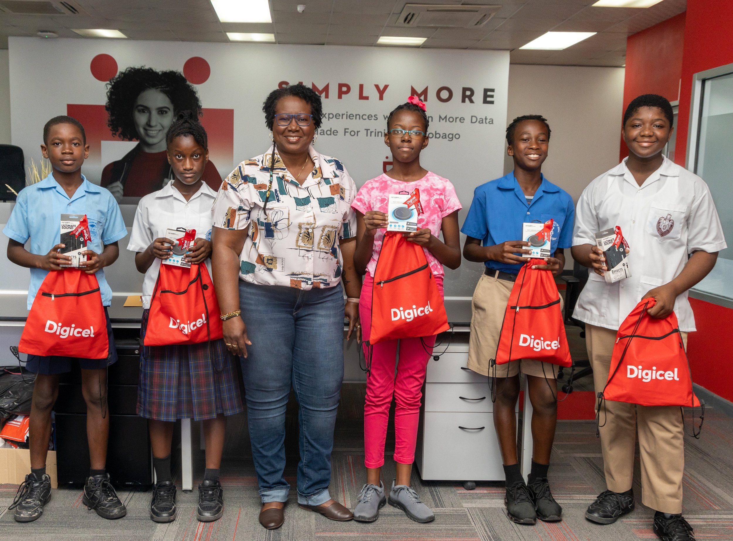 Digicel Foundation Board Director Georgina Peterkin (3rd from left) presents tokens and awards to students from Tobago who participated in the Caribbean Code+ Programme.
