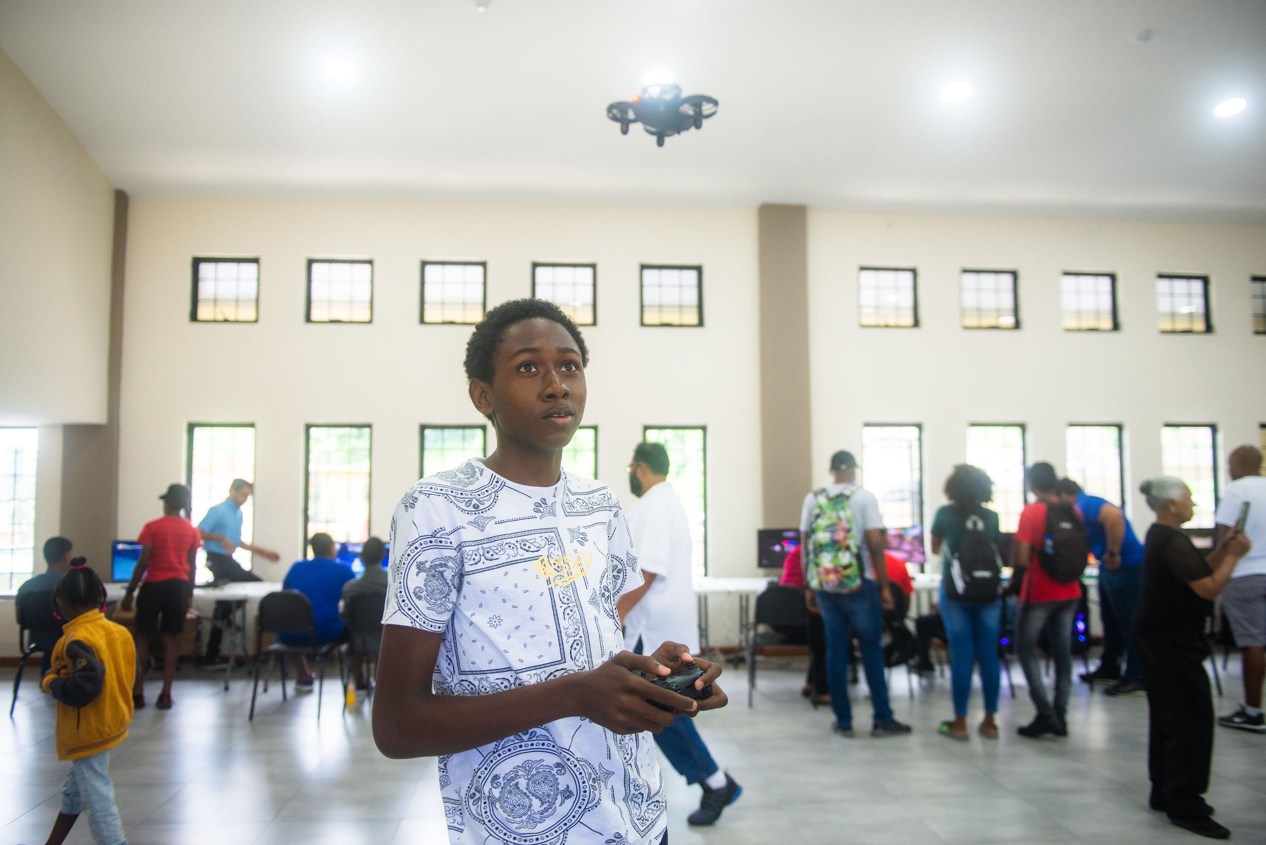 A camper is engrossed in flying a drone at the RSC Digikids Tech Incubator camp day at San Fernando Community Centre on 9 August 2023.