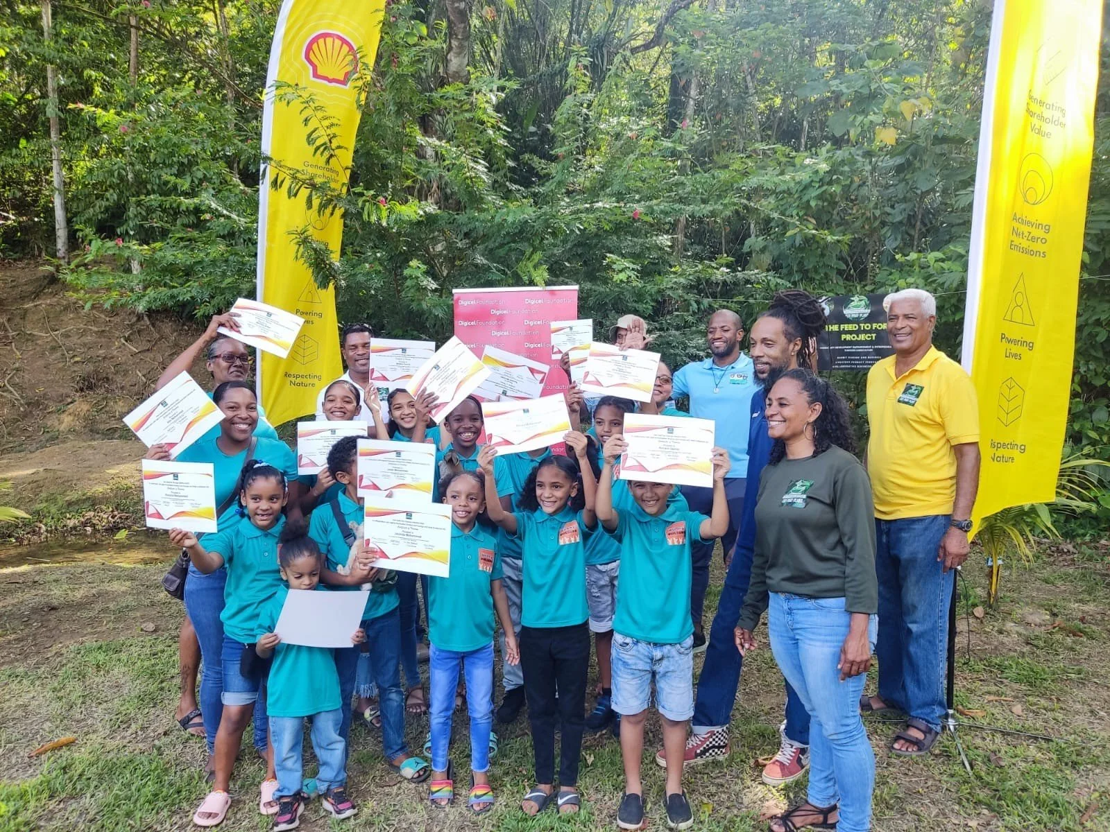  Certified Bunny Builders! Young residents of the Heights of Aripo who participated in the launch of a sustainable rabbit-rearing business venture this month proudly display their certificates with members of the One Seed for Change team. 