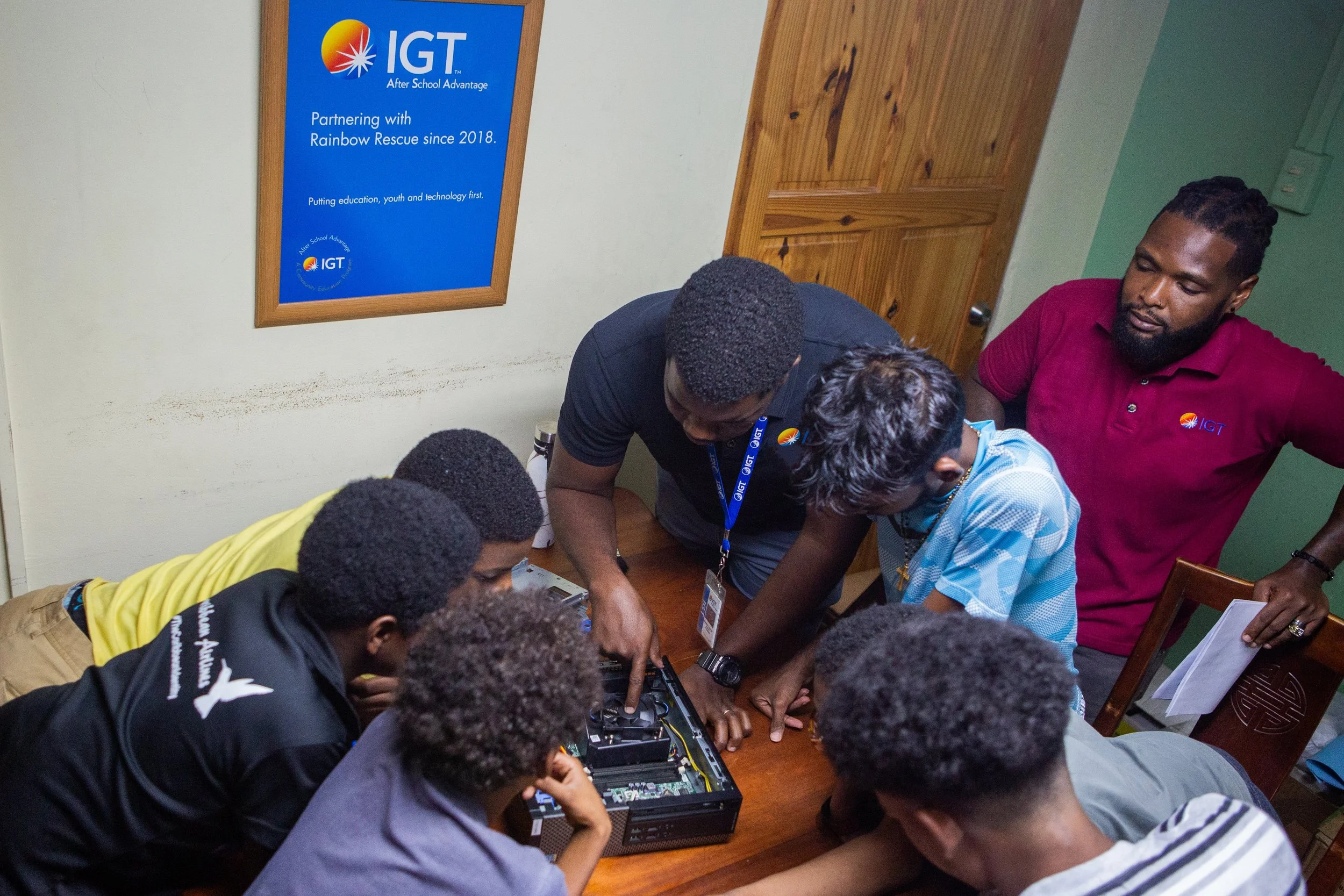 The boys from Rainbow Rescue gave IGT computer operators Shammah Quinton and Antonio Bradshaw their undivided attention while learning about computer components during IGT’s Mentorship Morning on Saturday 4 November, 2023.