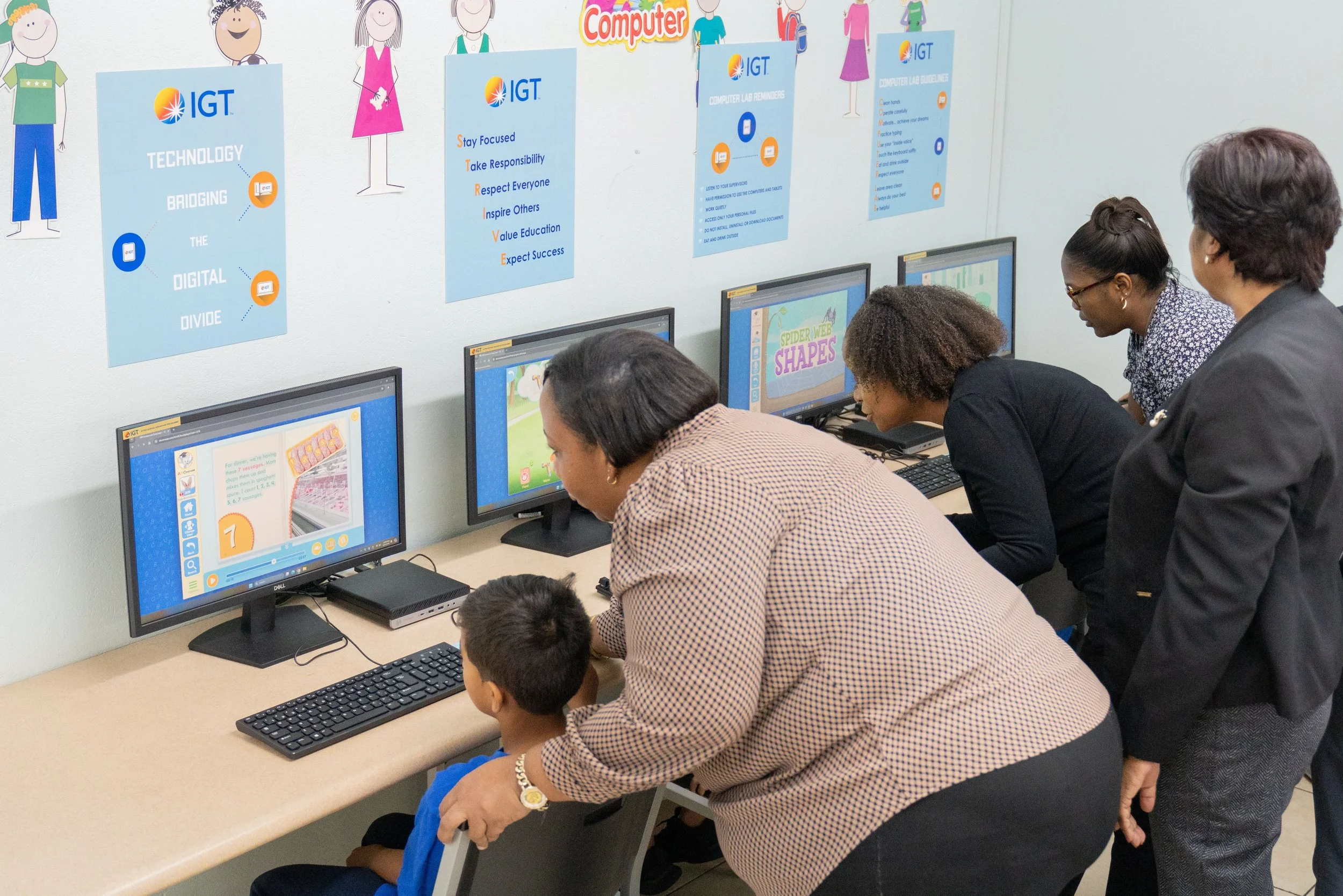 Collaborative learning on display! Representatives from IGT and the Credo Foundation for Justice guide students using the new online learning tools at the Credo Drop-in and Outreach Centre on Nelson Street, Port of Spain.