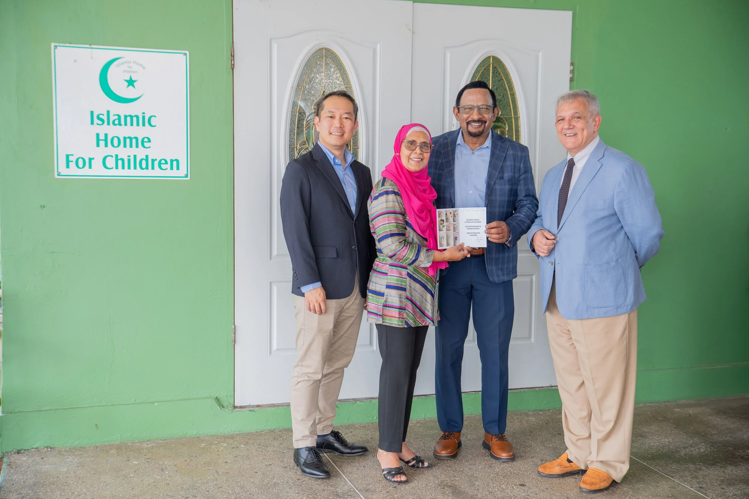 President of the Islamic Home for Children, Donna Ali presents a creative token of gratitude to the executives of Marubeni Power International, from left, Keisuke Harada, Senior Manager; Mo Majeed, Chief Operating Officer/Managing Director, Caribbean, and Damián Obiglio, Senior Vice President, Operations.