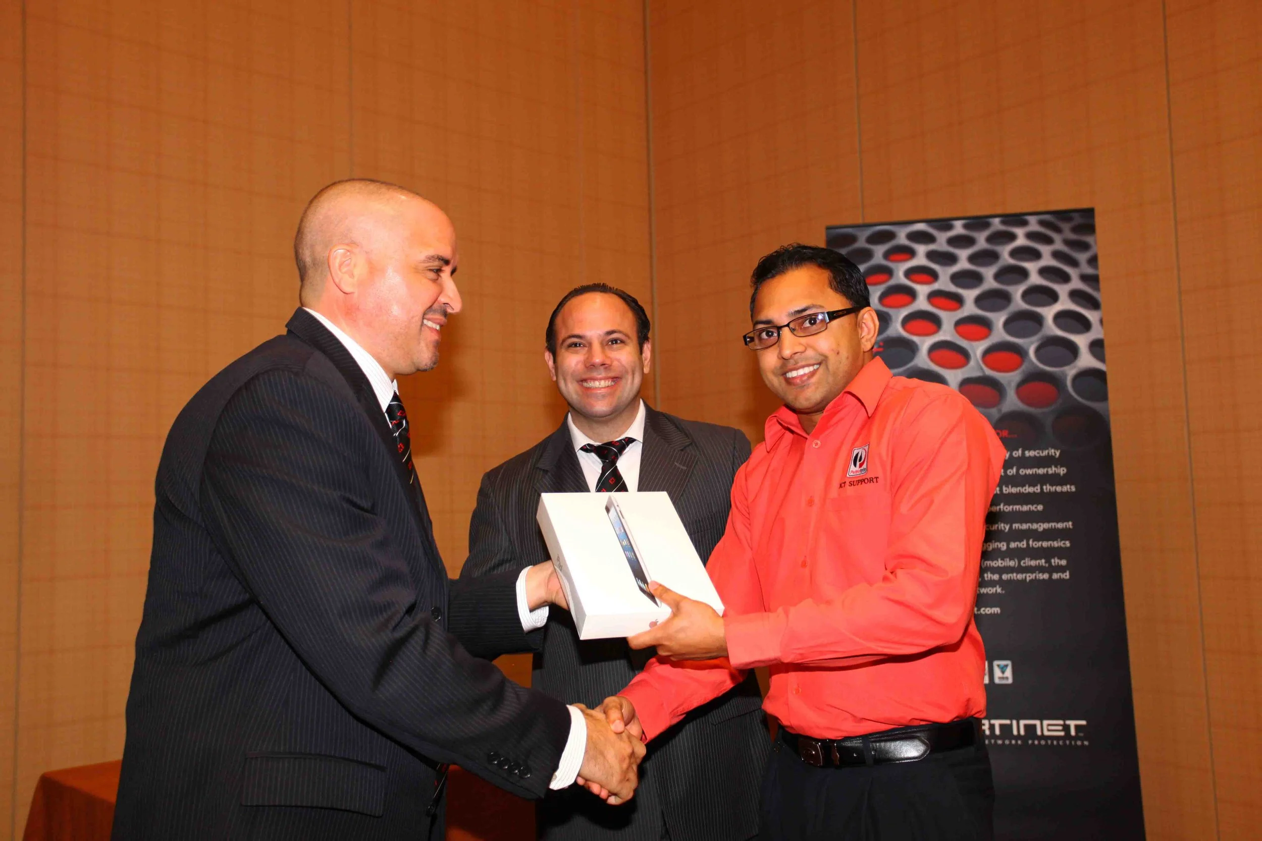 Sanjay Gayadeen of Petrotrin (right) receives his prize of an iPad from Gilbert Perez, Fortinet’s Country Manager for the Caribbean and Bermuda. Looking on is Hans M. Fermin, Fortinet’s General Manager for the Caribbean and Bermuda.