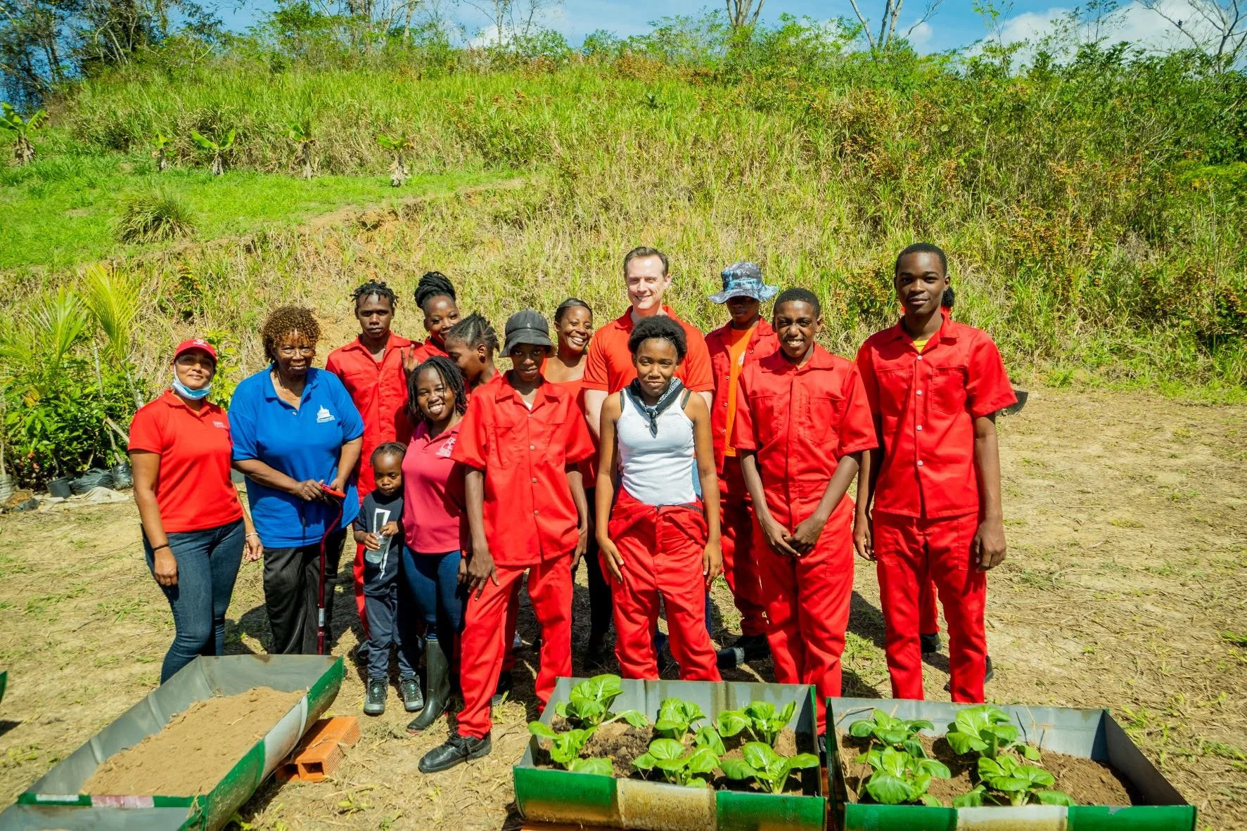 Digicel Foundation Project Officer Diana Mathura-Hobson (far left) and Digicel CEO, Abraham Smith (back centre) pose for a photo with some of the young beneficiaries of the ‘Planting Seeds with a Purpose’ initiative in Marabella.