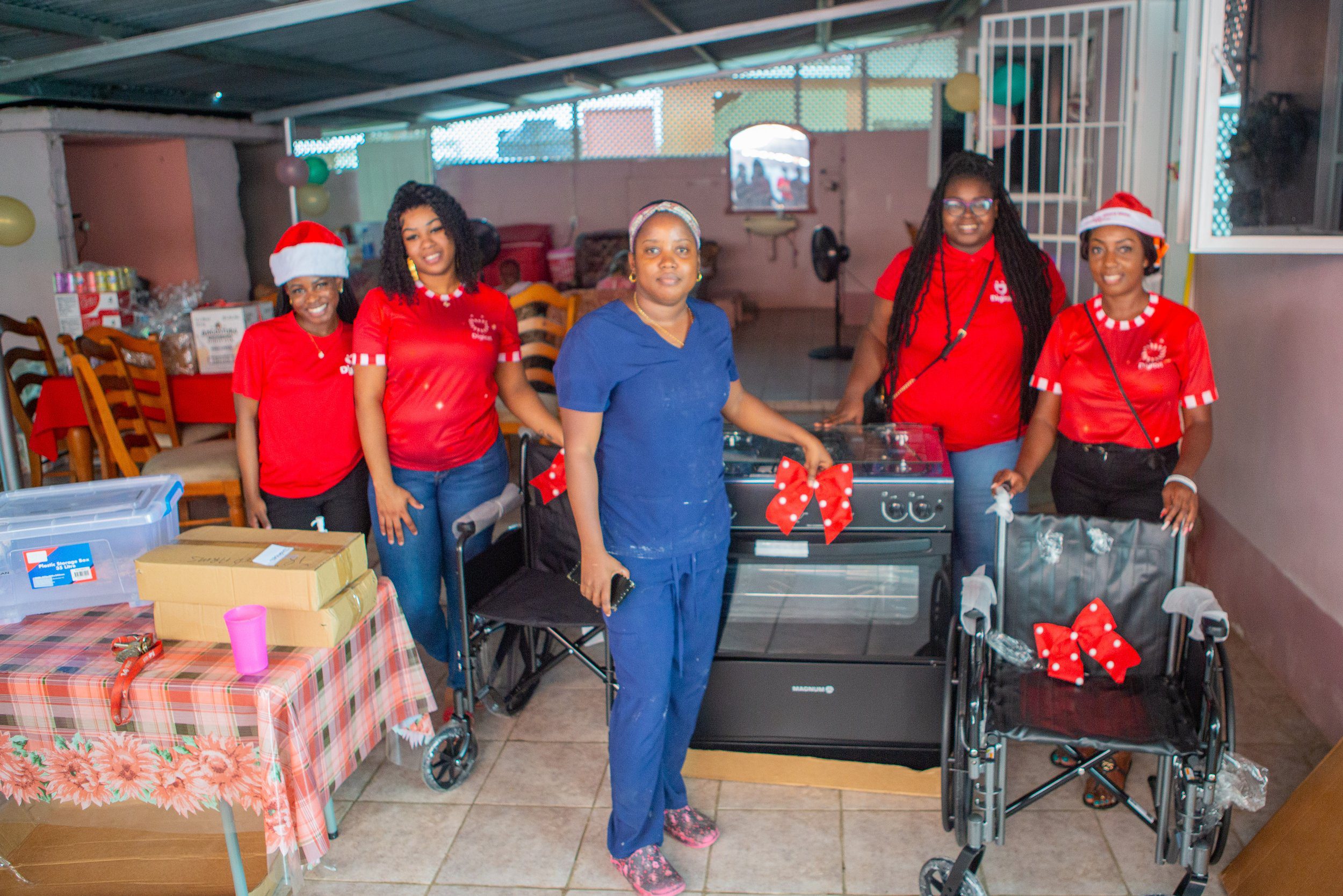 Spreading the Christmas Spirit! Digicel Foundation Mobile Telesales Team (L-R) Seriah Hills, Cadesha Romany, Dinique Little and Kathy Ann Richardson pose with Owner of Afeisha’s Home for the Aged, Afeisha Spencer-Mohammed (Middle) and their donation on Christmas Eve!