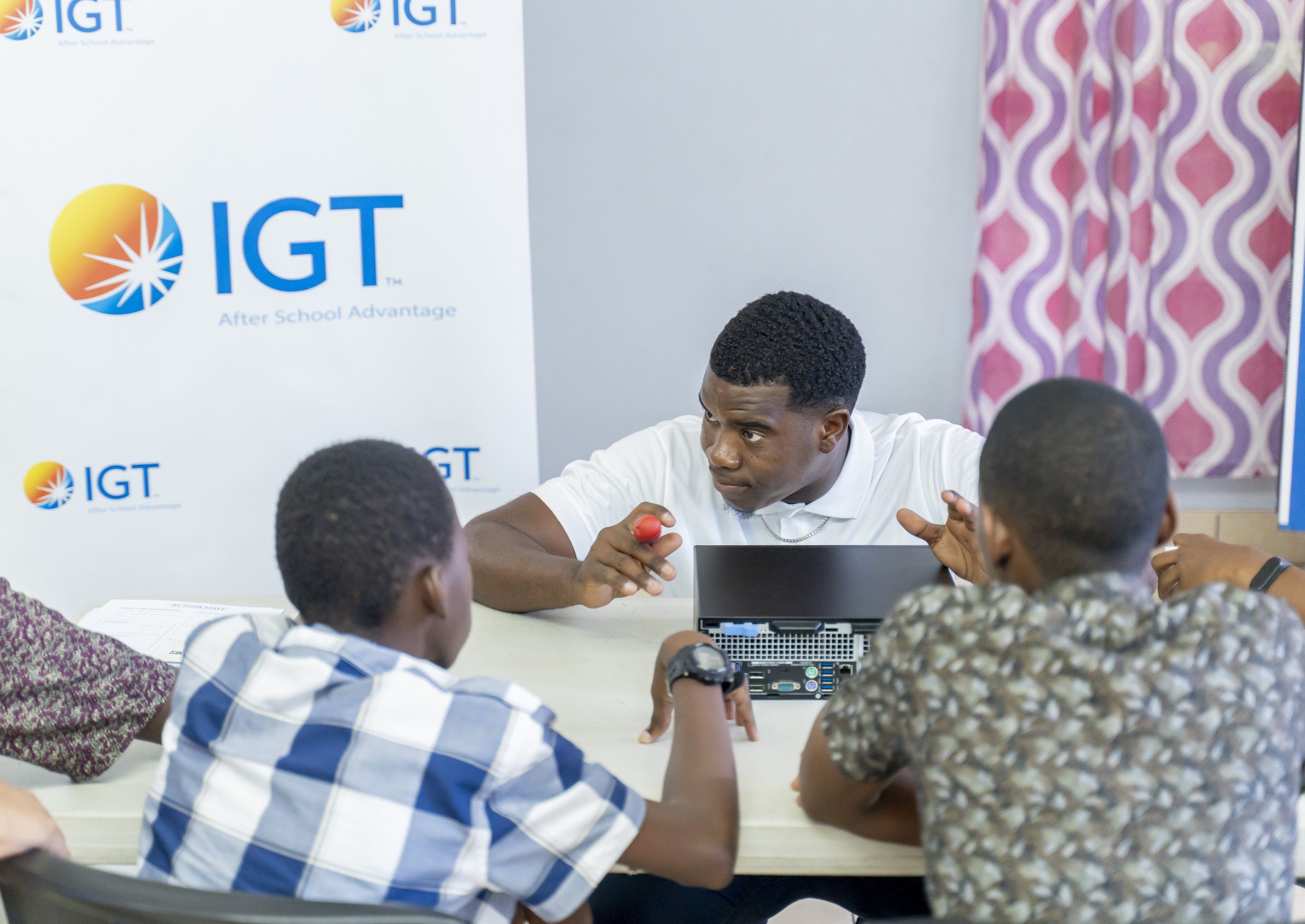 IGT Systems Administrator Shammah Quinton demonstrates how to assemble a computer as part of IGT’s Big Brother mentorship programme at the Credo Home for Boys.