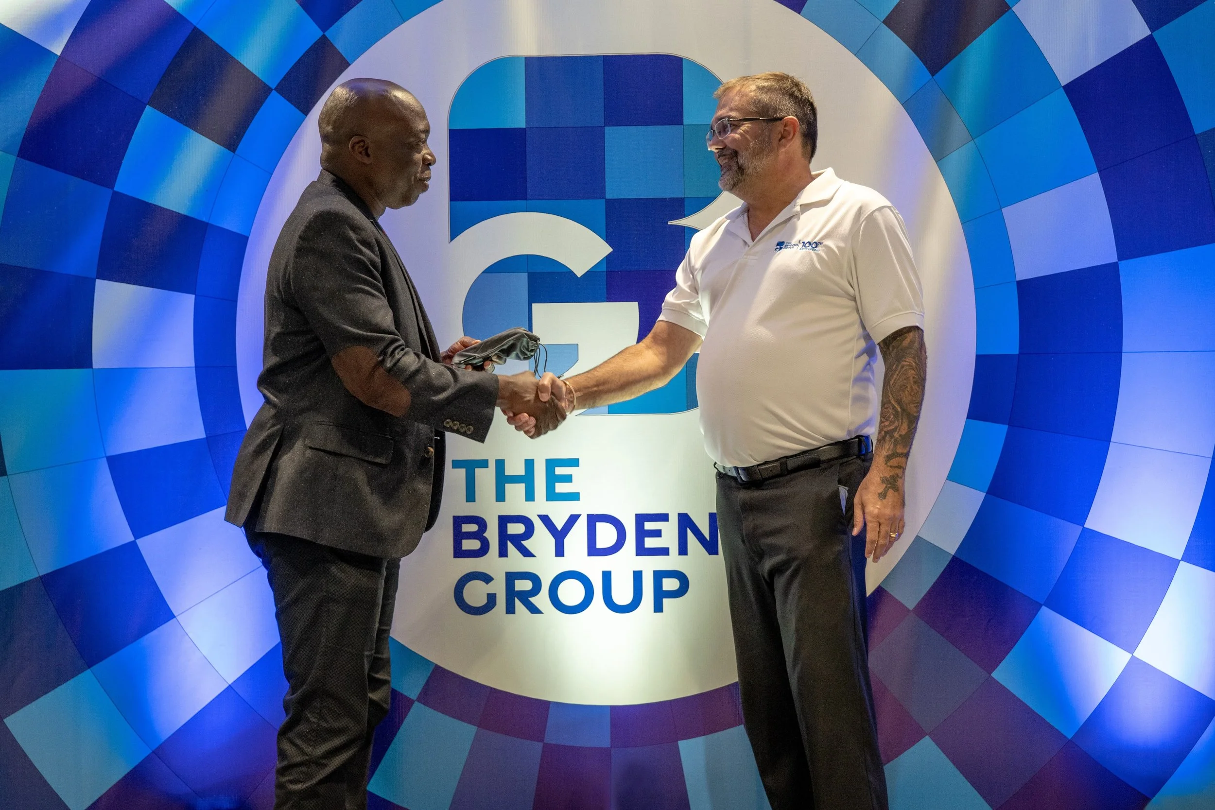 Scott Franco, Head of Shared Services & Special Projects, The Brydens Group (on the right), shakes hands with Sherwin Joseph, Assistant Team Manager of the Trinidad and Tobago Carifta Games team, at the Brydens headquarters, San Juan, on 11th April.