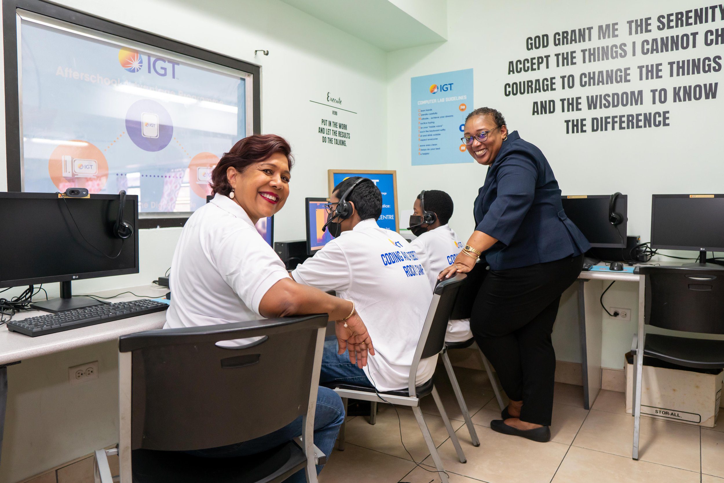 Shavindra Tewarie-Singh, IGT Senior Regional HR Manager (left) and Leslie Ann Baxam, Draw Coordinator Lead at IGT (right) pose for a quick photo while supervising students during the third virtual IGT Coding and Robotics Rock! Camp held from 17 - 28 July.