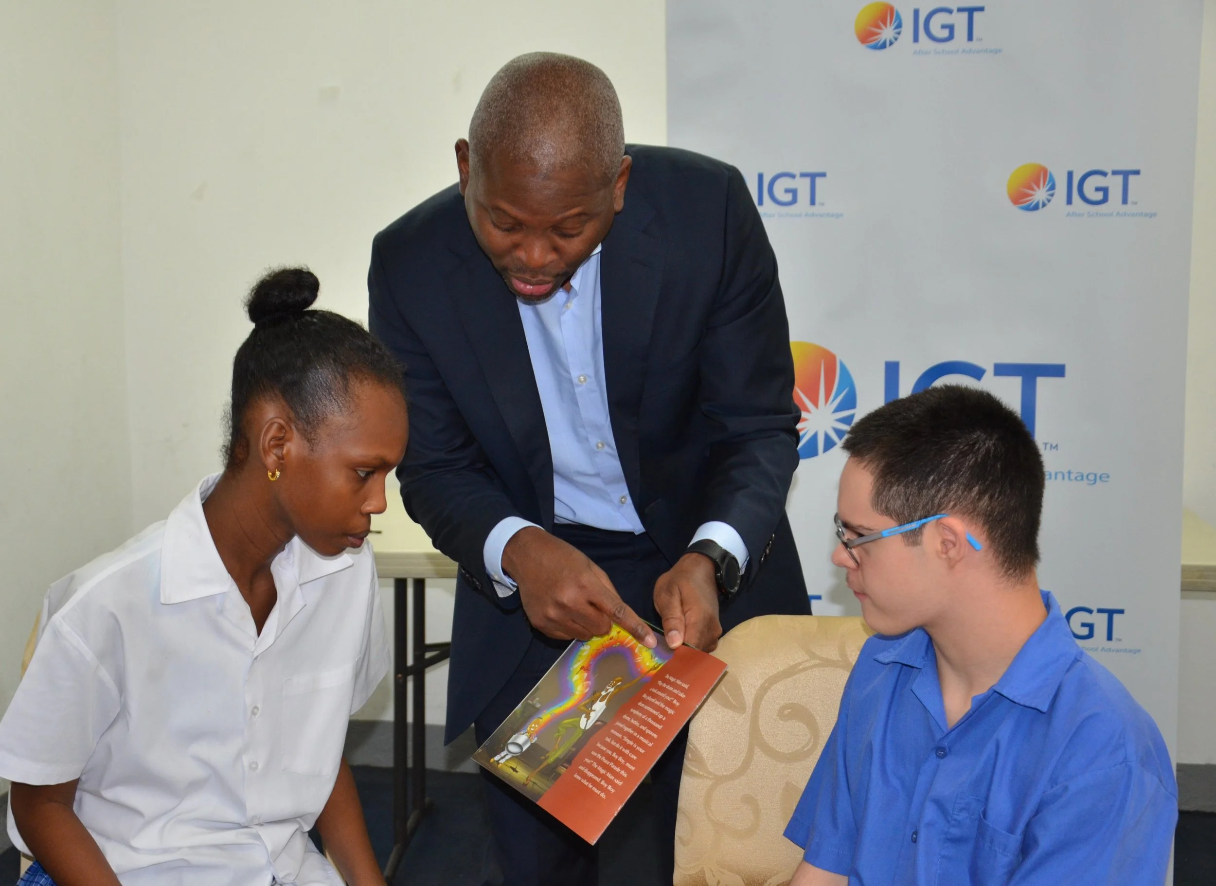 IGT General Manager Dexter W. Thomas engages students in a storytelling activity during IGT’s Global Giving Month activities on 24 May at the Immortelle Centre.
