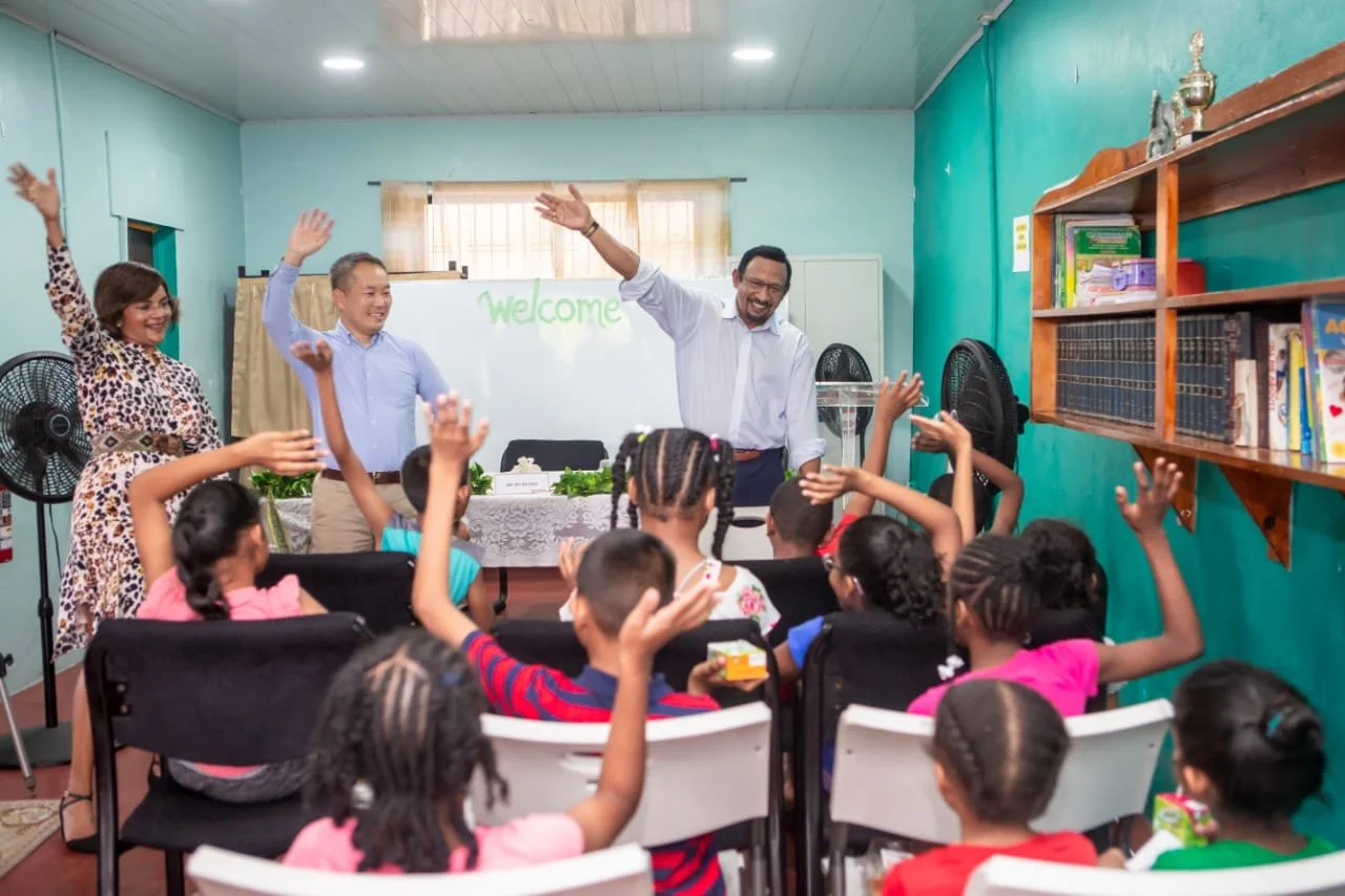 (From left) Dr Indira Couch, Hope Centre’s Chairperson, Mr. Keisuke Harada, Senior Manager, Marubeni Power International Inc, and Mr. Mo Majeed, COO, Managing Director Caribbean Operation of Marubeni Power International Inc, share a light moment with the children of Hope Centre on April 16.