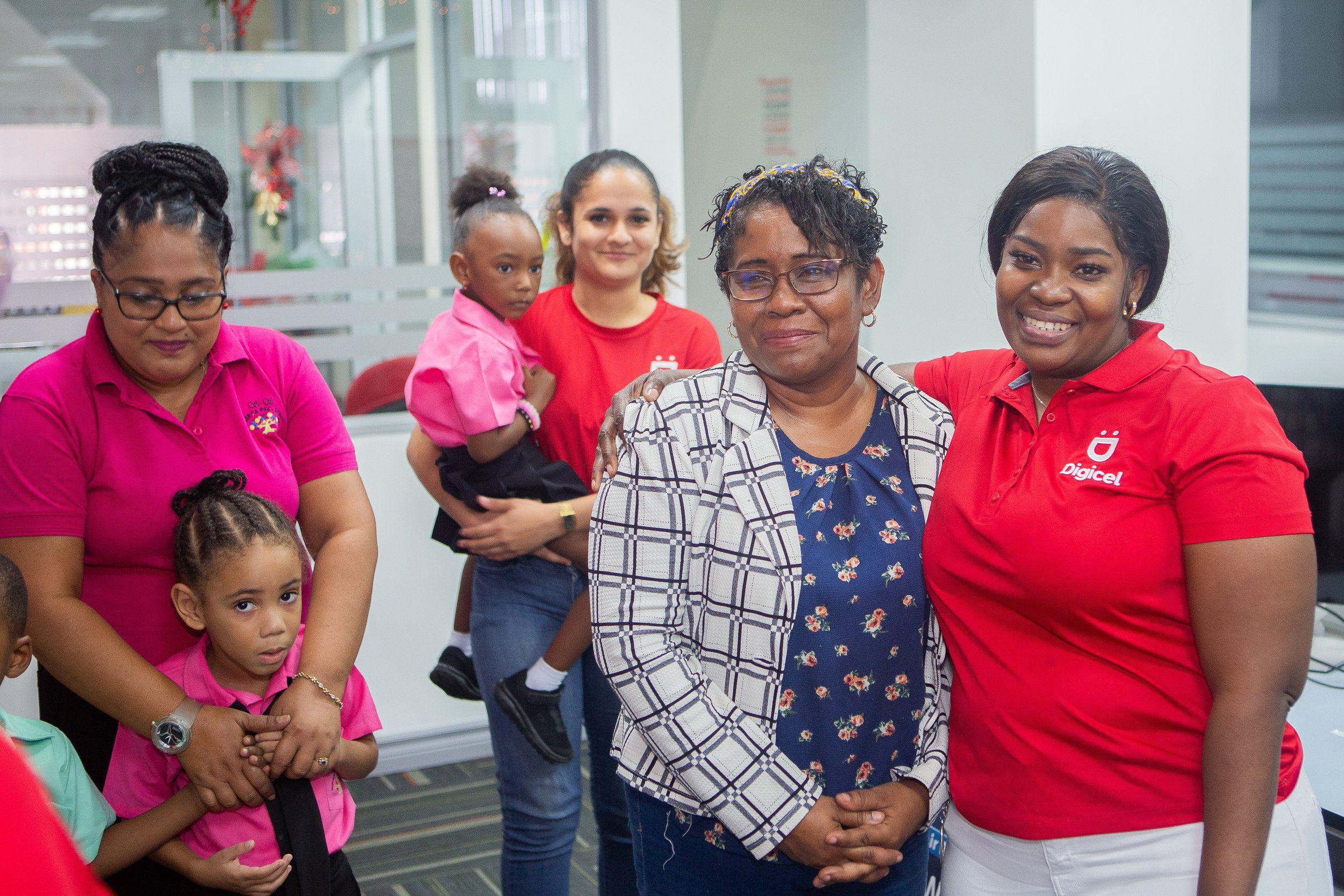 Principal of Nelson Street Boys Primary School, Mrs. Frances Gerais-Heath, and students of SS Nursery and Preschool are showered in warmth by the Digicel Team that made a large Christmas donation to both schools.