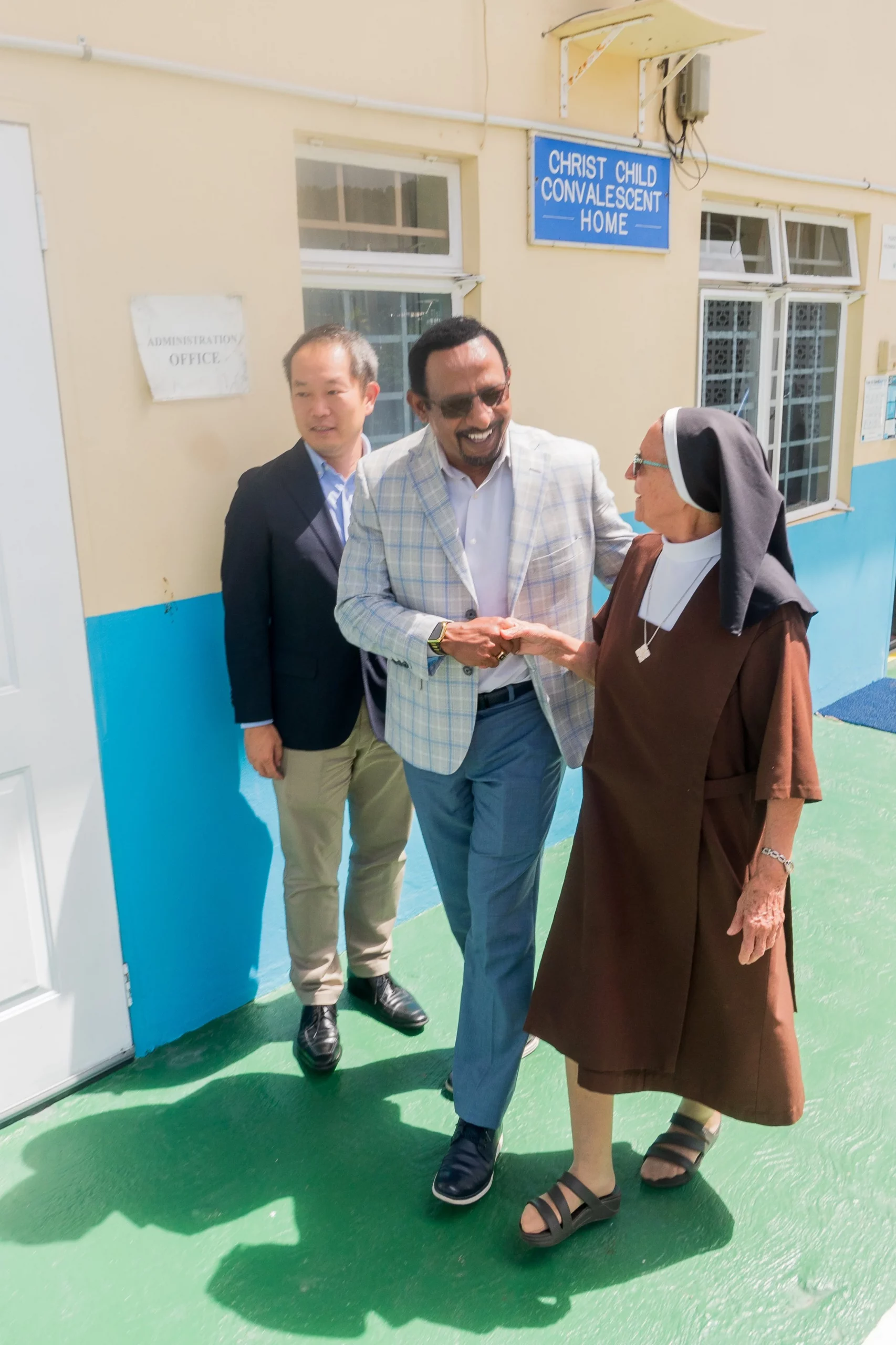 Marubeni Power International Inc. executives Mo Majeed, COO/Managing Director Caribbean (centre), and Keisuke Harada, Senior Manager, receive a warm welcome to Christ Child Convalescent Home from Sr. Annunciata De Souza, the Home’s Manager, on June 20 2024.