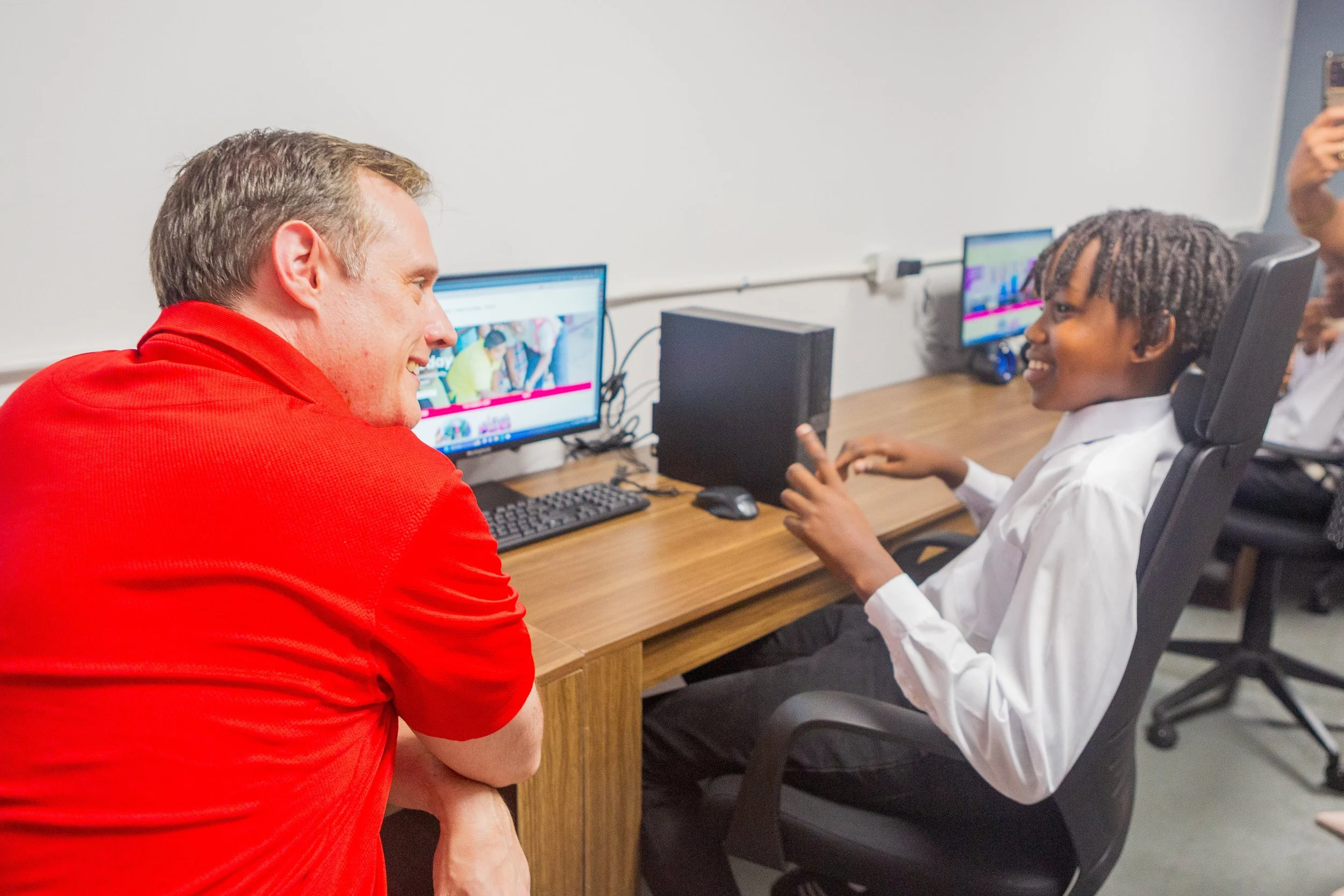  Abraham Smith, CEO of Digicel Trinidad and Tobago and Board Director of the Digicel Foundation, chats with a young pannist at the launch of the Technology in Education Centre at Pandemonium Panyard in Belmont in February 2024. 