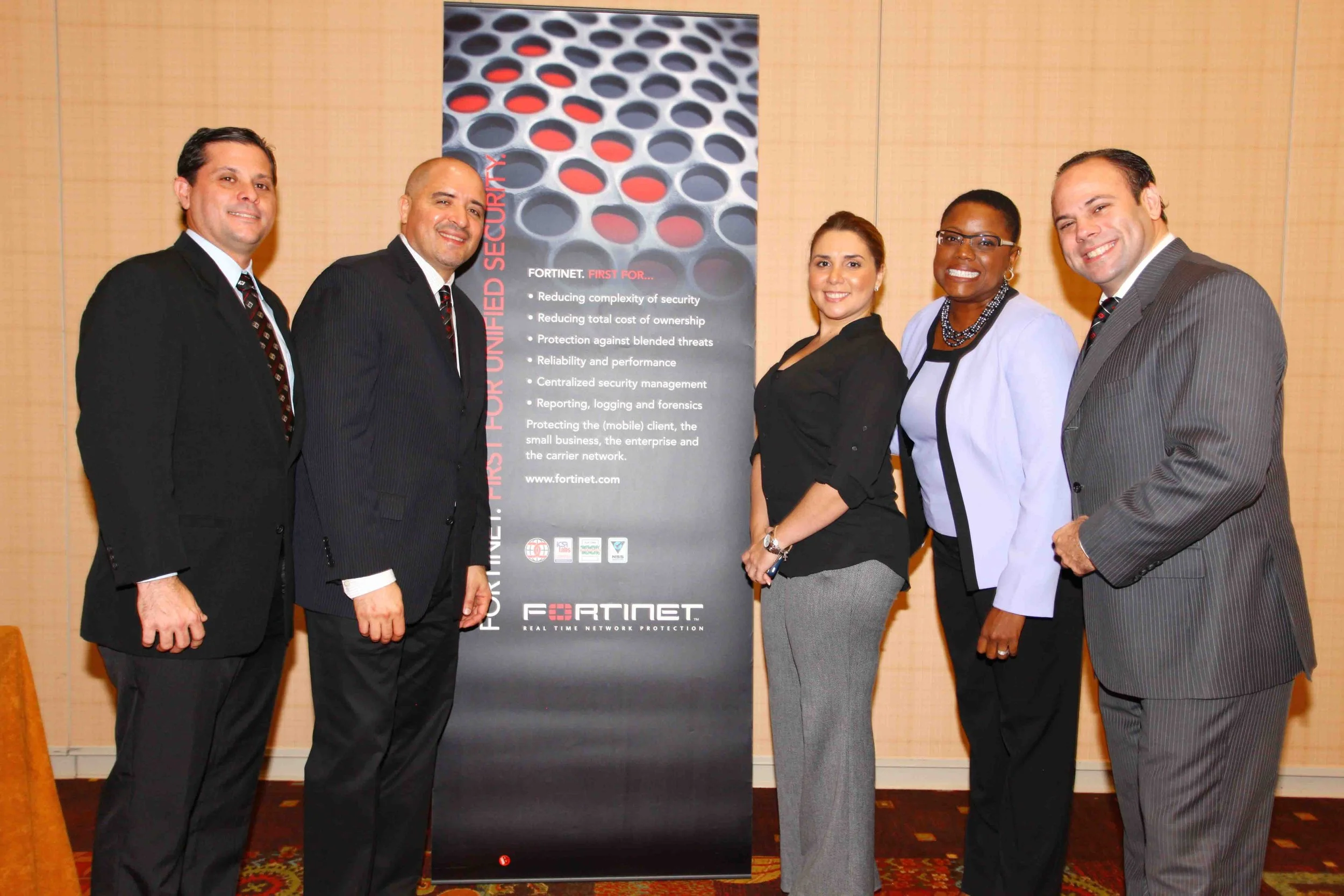The Fortinet team (from left) Gilberto Rivera, Systems Engineer, Gilbert Perez, Country Manager for the Caribbean and Hans Fermin, General Manager for the Caribbean and Bermuda (right) are seen here with Karla Edwards, General Manager of Metropolitan Networks, Trinidad (second from right) and Belmarie Gonzalez Estevez, Channel Territory Manager for Westcon (third from right).