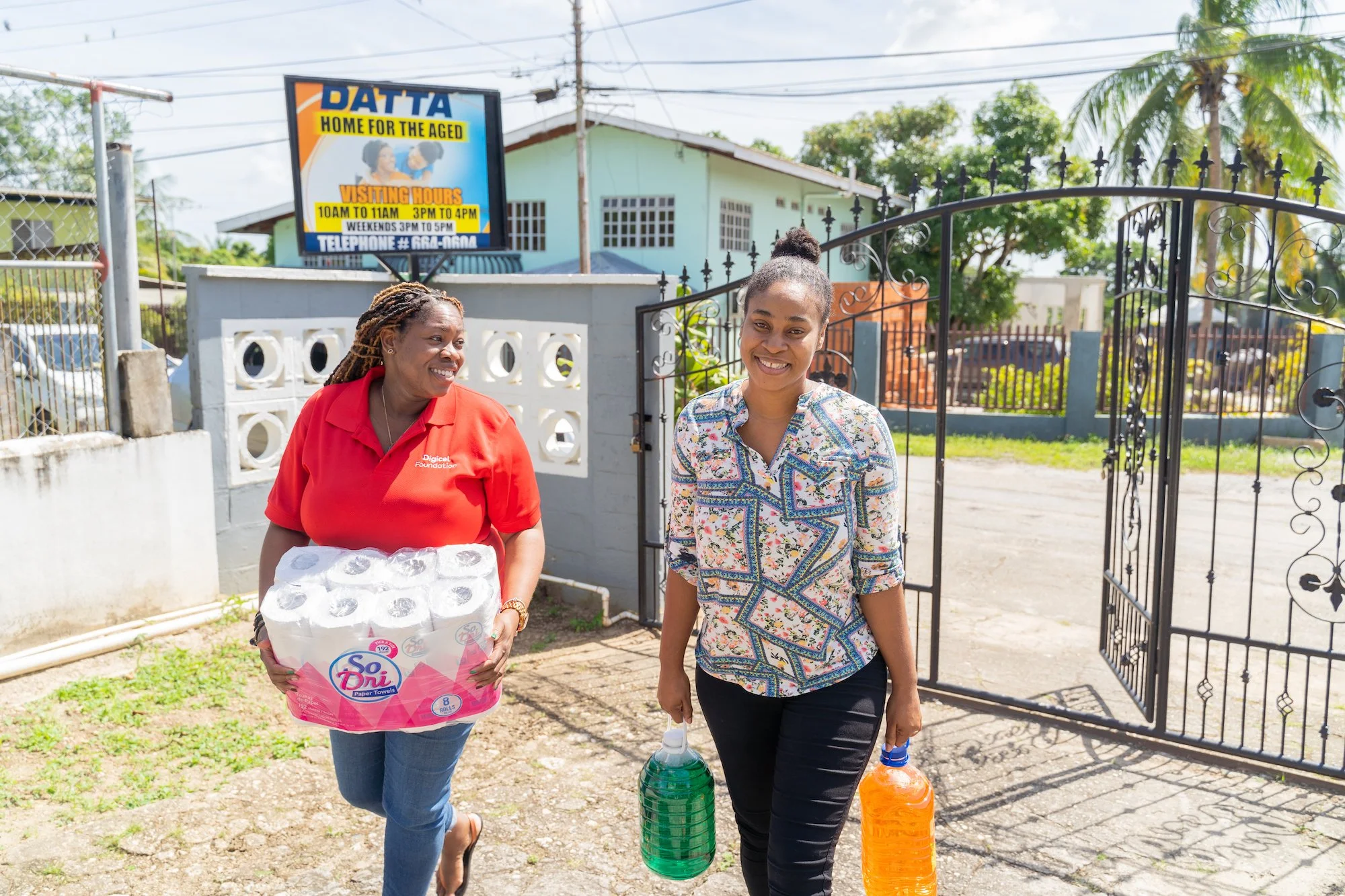 Cindyann Currency, Operations Manager of Digicel (Trinidad & Tobago) Foundation (left) and Ria Moore-Best, Digicel Business Risk Analyst (right), arrive at Datta’s Home for the Aged in Arima with a large donation of personal care items and cleaning products for the Home, purchased with the Digicel Foundation #CommunityEveryting staff grant.