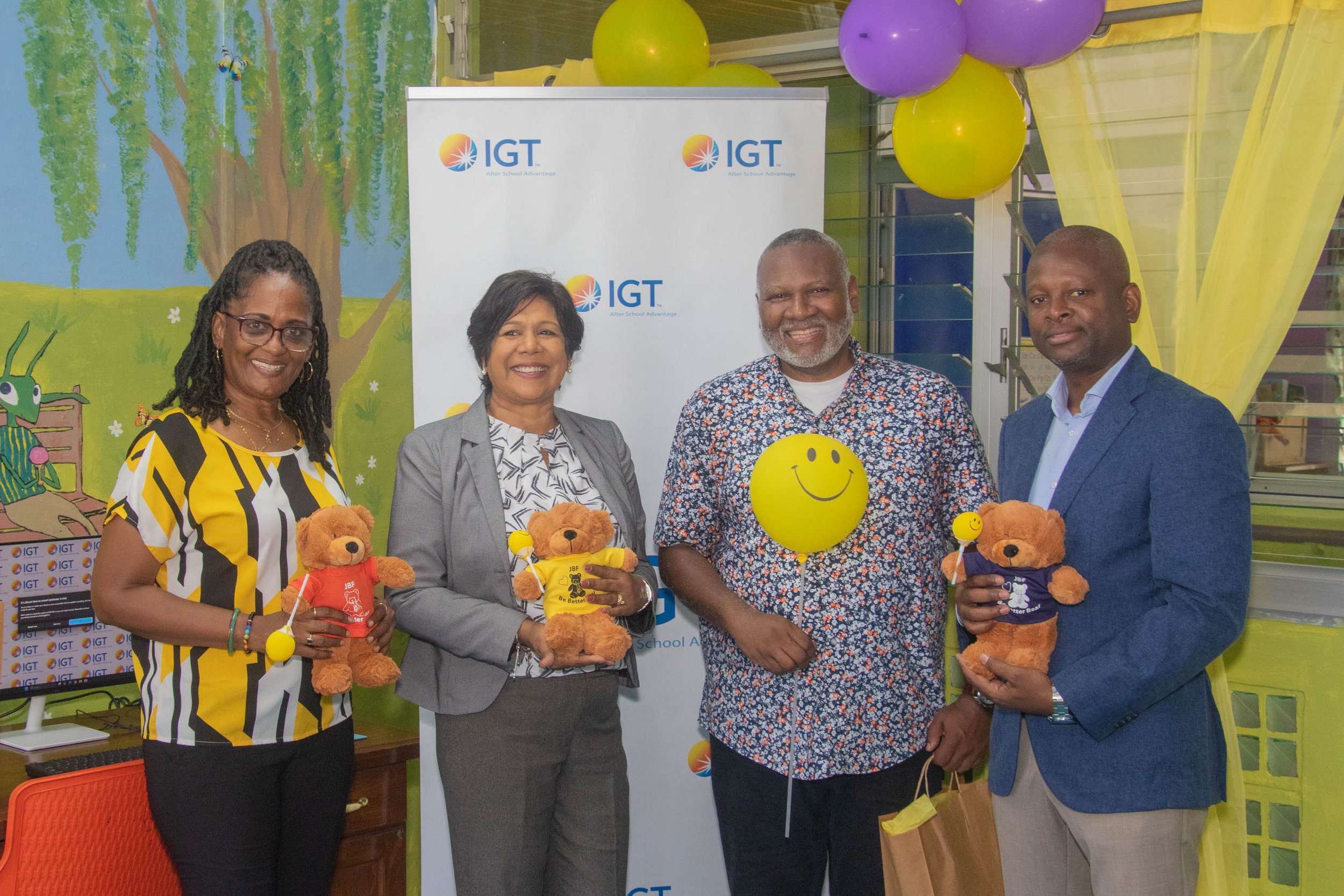 (L-R) Chevaughn Joseph, Co-Founder of the Just Because Foundation, Shavindra Tewarie-Singh, IGT’s People & Transformation Regional Senior Manager, Noel Joseph, Co-Founder of the Just Because Foundation, and Dexter Thomas, IGT’s General Manager, Trinidad and Tobago, display the JBF Be Better Bears.