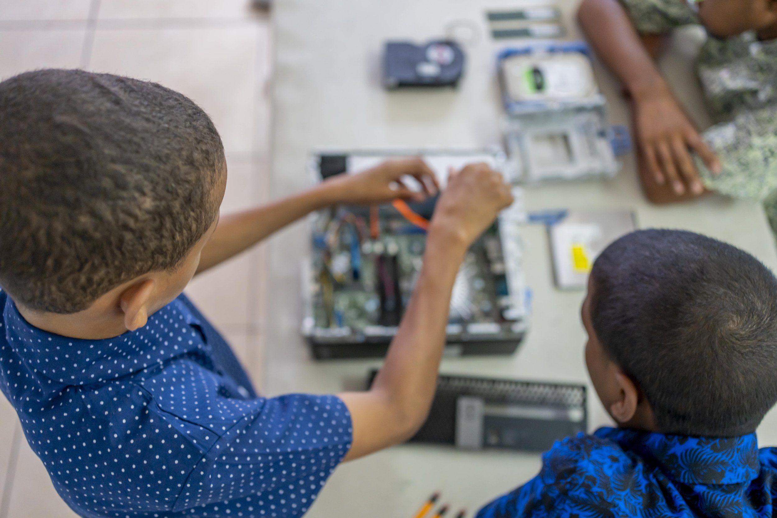 These boys get hands-on experience assembling computers during IGT’s Big Brother mentorship programme at the Credo Home for Boys.