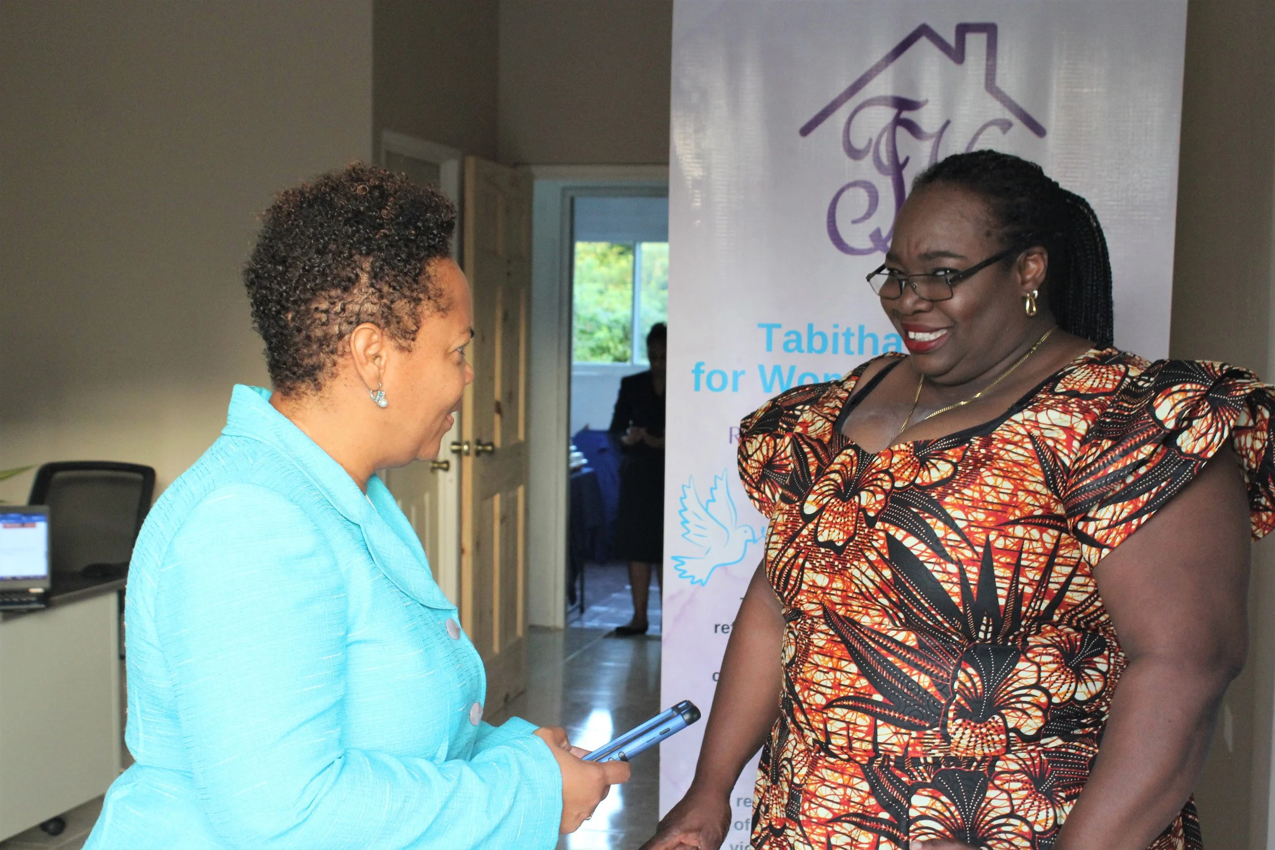   (L-R)  President of Tabitha’s Home for Women and Children Rowena Pitt and Treasurer Donna Grant Moore share a light moment at the Home’s launch event on 15 December.  
