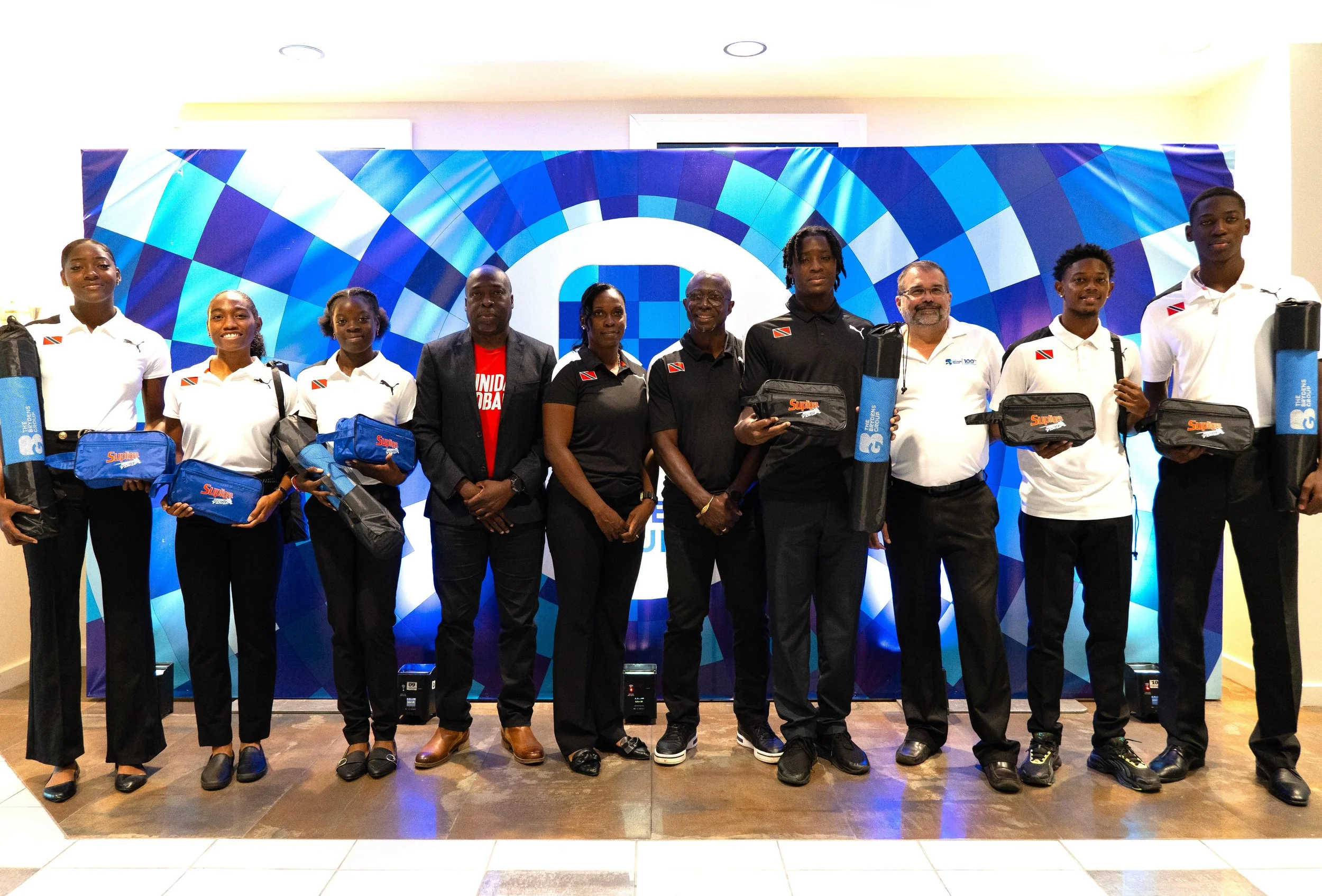 Representatives from the Trinidad and Tobago Carifta Games team pose with Scott Franco, Head of Shared Services & Special Projects, The Brydens Group (third from the right), following the handover of Brydens’ donation to the team on 11th April.