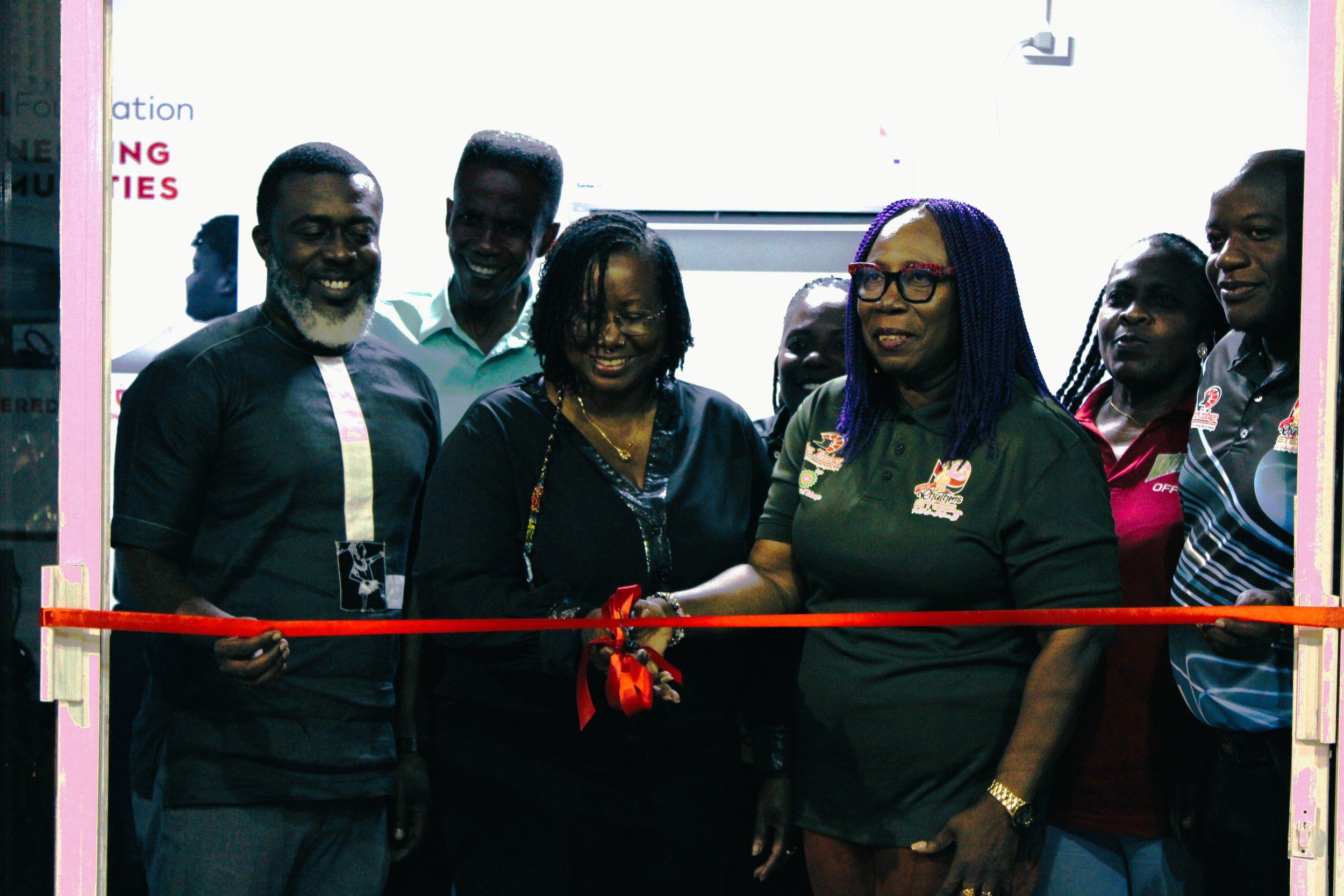  Beverley Ramsey-Moore, President of PanTrinbago (centre right), and Georgina Peterkin, Digicel Foundation Director (centre left) cut the ribbon on the Technology in Education Centre at the Katzenjammers Steel Orchestra, Black Rock, Tobago on Wednesday 13 March 2024. 