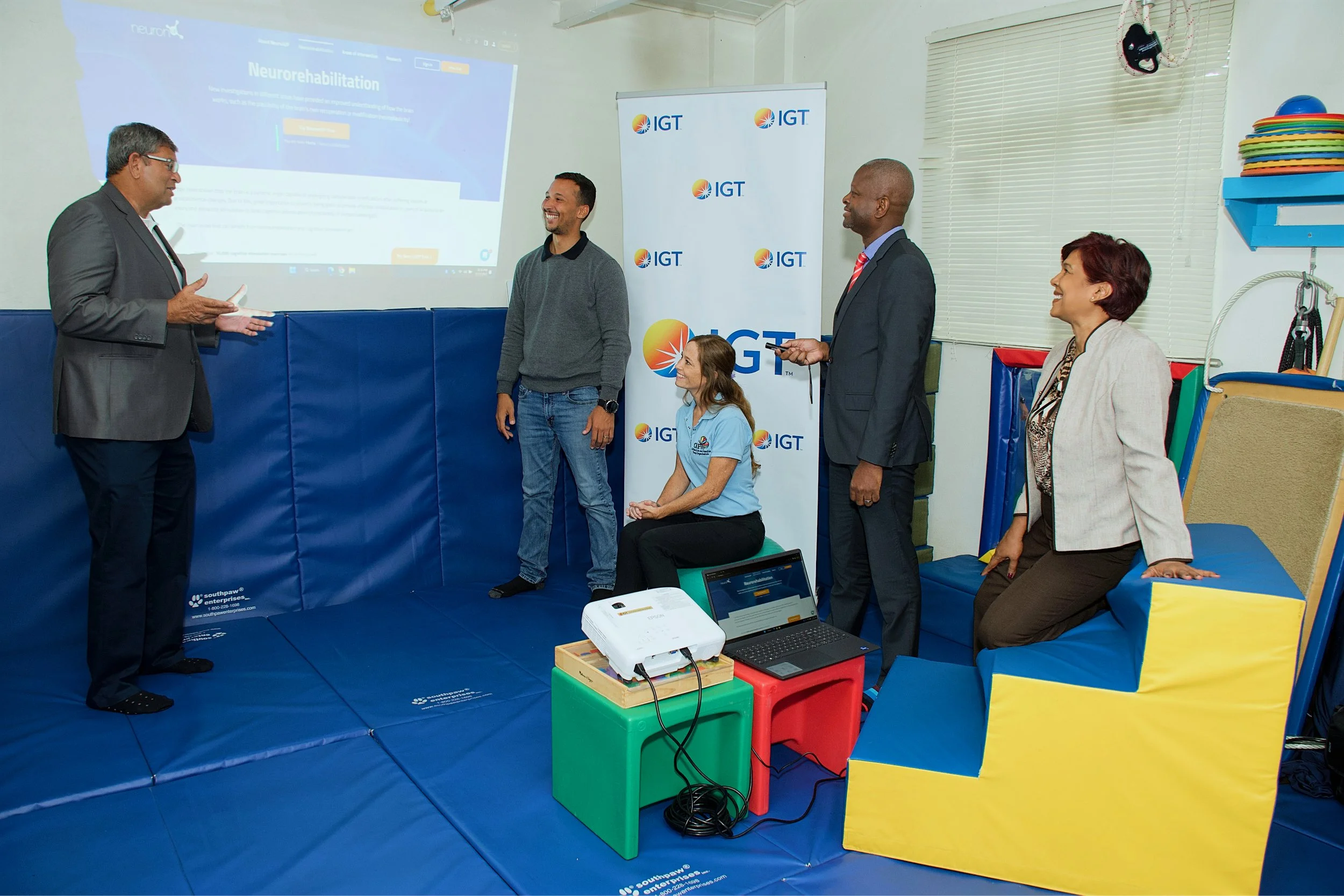 From left to right, Roger Bolai, IGT Regional Director; Christopher Ristic, CKFTO Senior Registered Occupational Therapist; Krista Hamel-Smith, CKFTO General Manager; Dexter Thomas, IGT General Manager; and Shavindra Tewarie-Singh, IGT Senior Regional Human Resources Manager Caribbean, test the newly installed equipment at CKFTO’s pediatric therapy clinic.