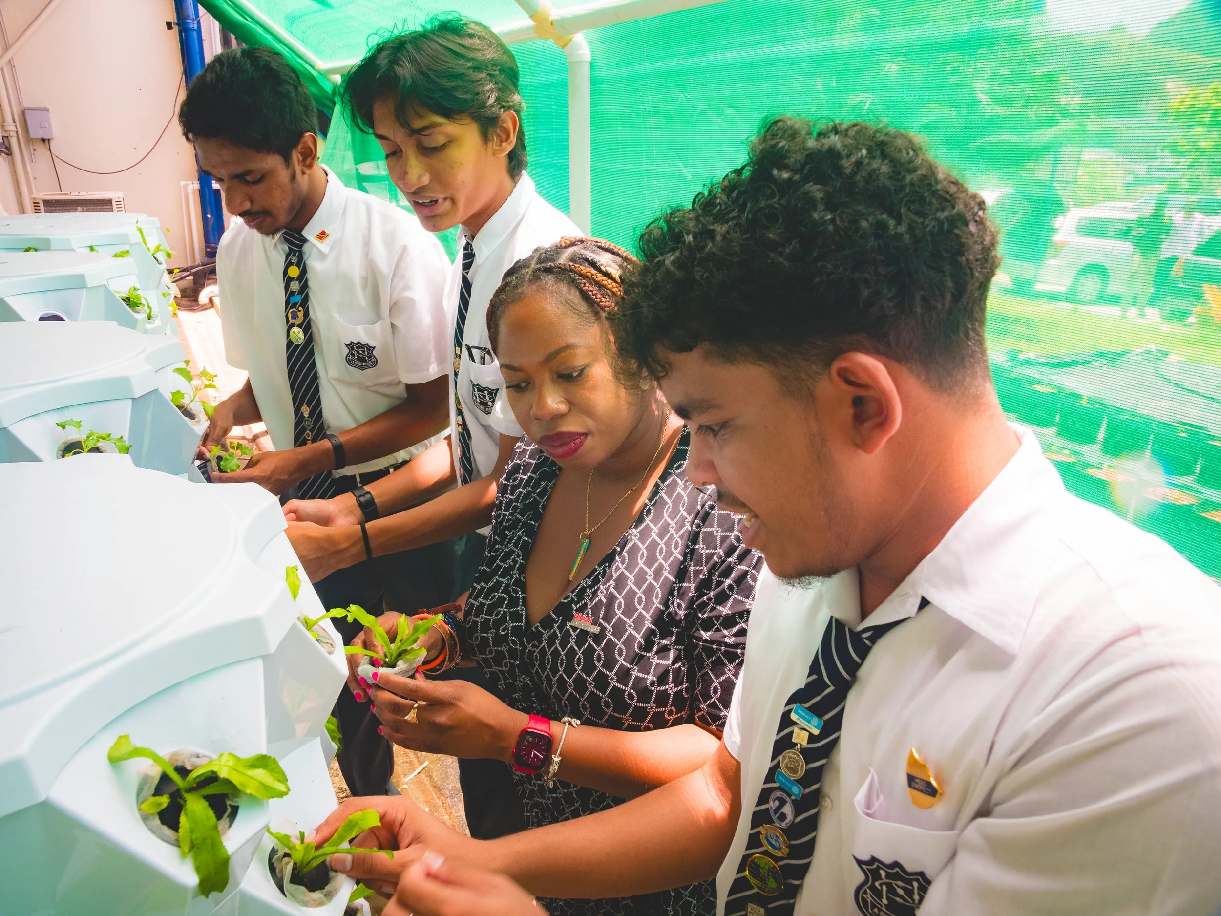 Cindyann Currency, Digicel Foundation’s Head of Operations, learns more about the SolarPonix system at the Naparima College from students at the project launch on Tuesday 23 April 2024.