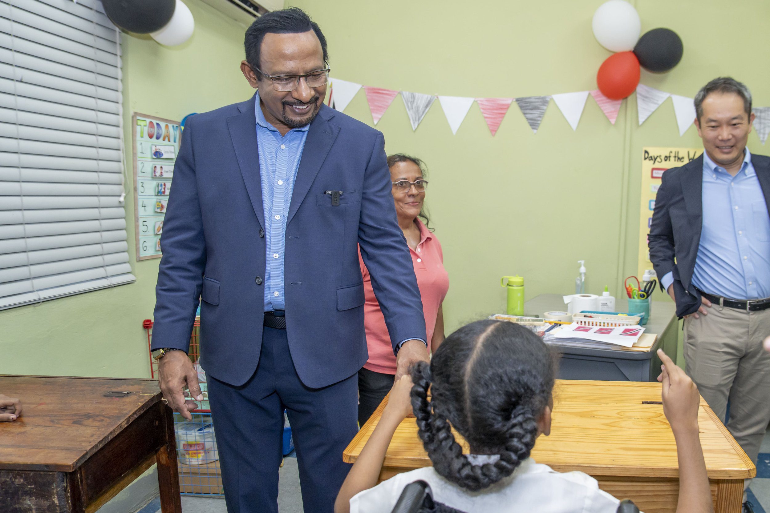 Students of the Immortelle Children’s Centre for Special Education bring smiles to the faces of Marubeni Power International Inc representatives Mo Majeed, COO/ Managing Director (on the left), and Keisuke Harada, Senior Manager (on the right).