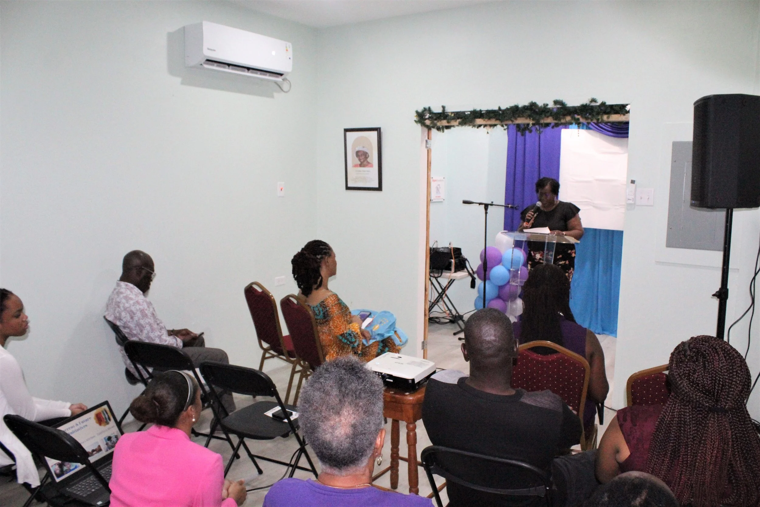  Georgina Peterkin, Digicel Foundation Board Director, addresses visitors from the podium during the launch of the newly renovated building for Tabitha’s Home for Women and Children in Tobago. 