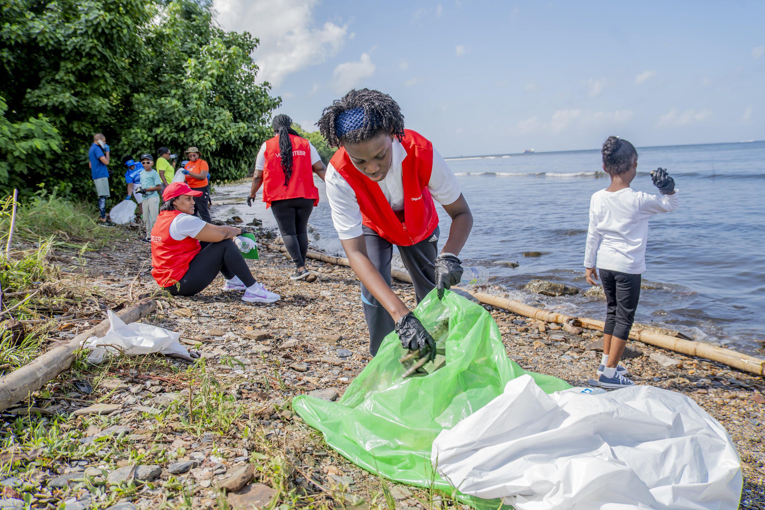 Digicel volunteers work steadily through the hot morning to remove litter from the Foreshore.