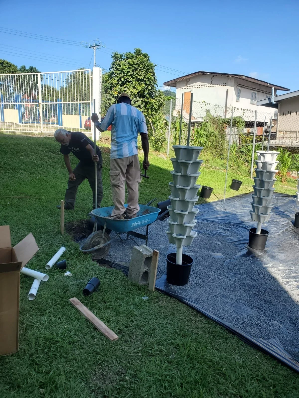 Residents participate in the process of installing the new hydroponic units at Court Shamrock, with guidance from K.O.D.I Greens and Young Farmers food Production Limited.