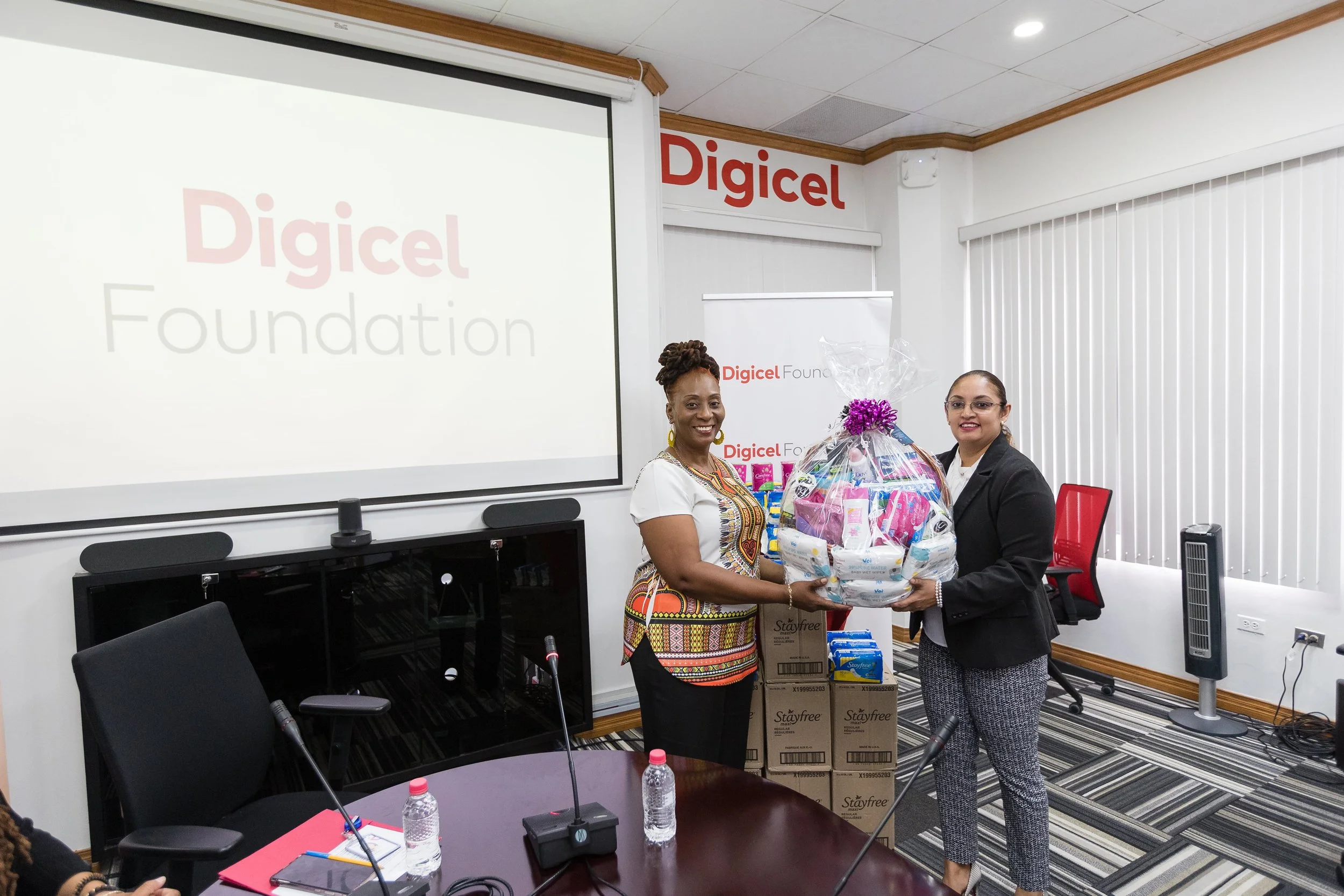 Digicel Foundation Board Director Bibi Mohammed (Right) presenting the hamper of feminine products to Carla Griffith, Executive Member ‘I am Laventille’ Foundation.