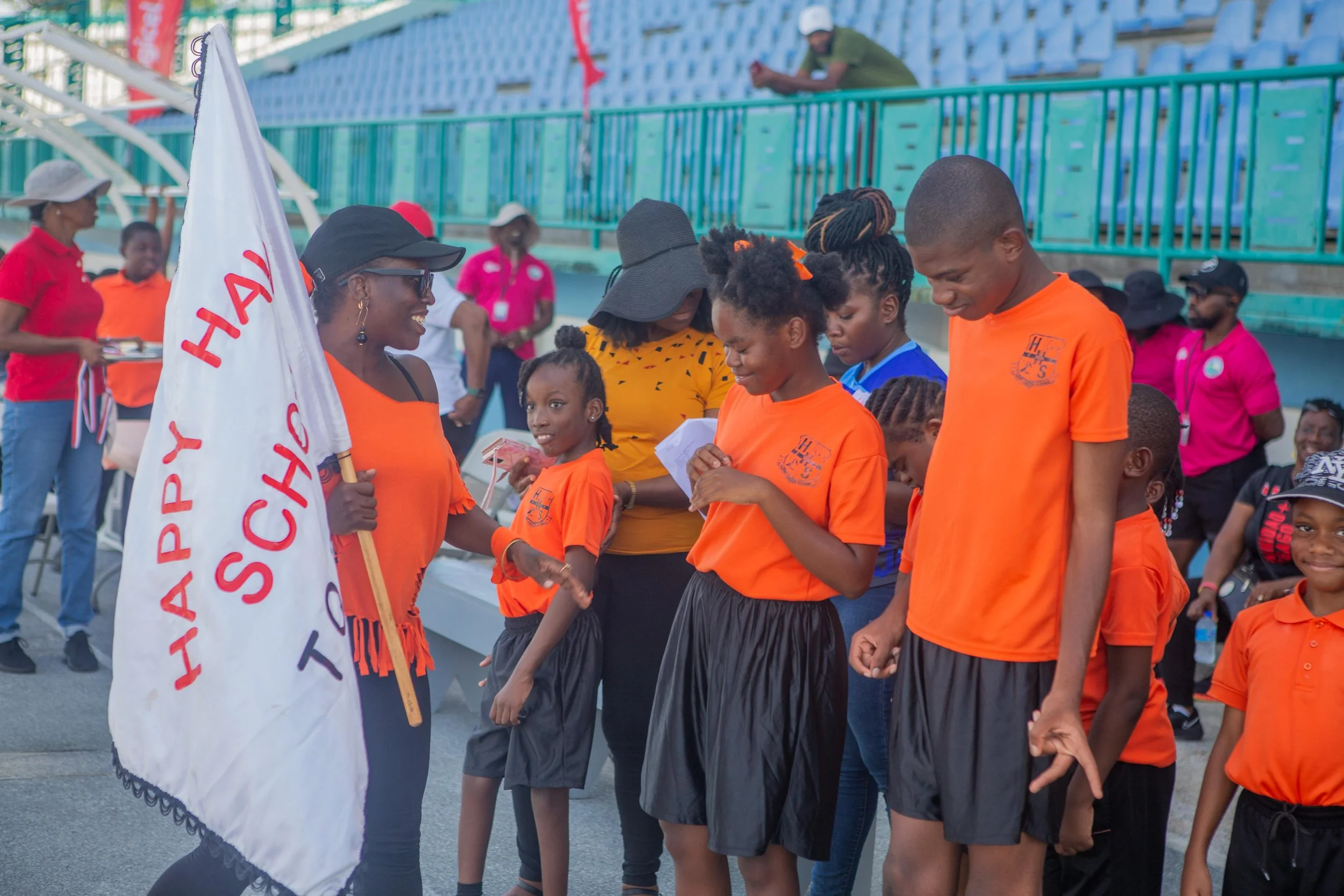 All smiles and ready for action! This flag bearing supporter keeps her Happy Haven School team well motivated and appreciated.