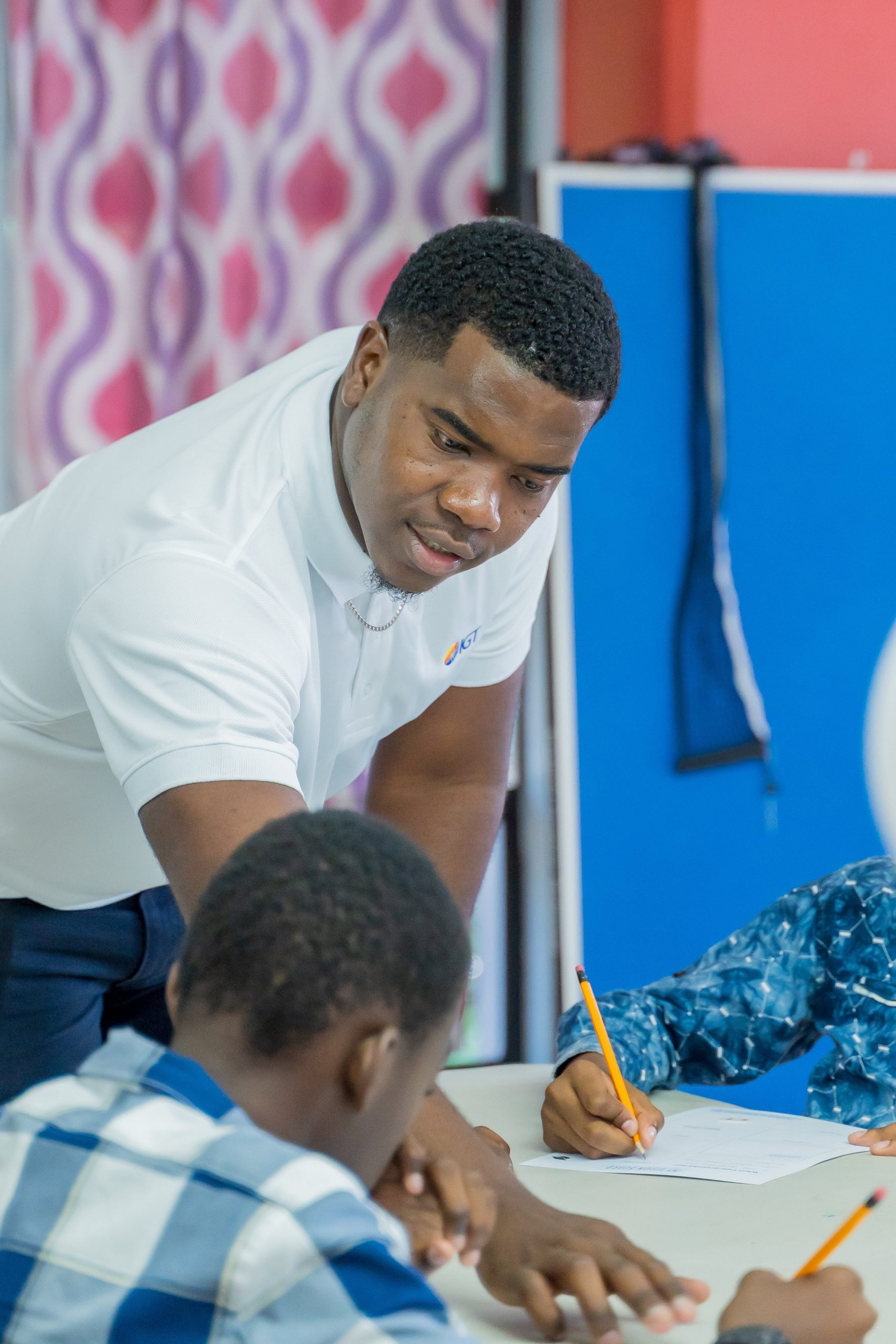 IGT Systems Administrator Shammah Quinton helps this young man with his career vision board as part of IGT’s Big Brother mentorship programme on Saturday 2 November.
