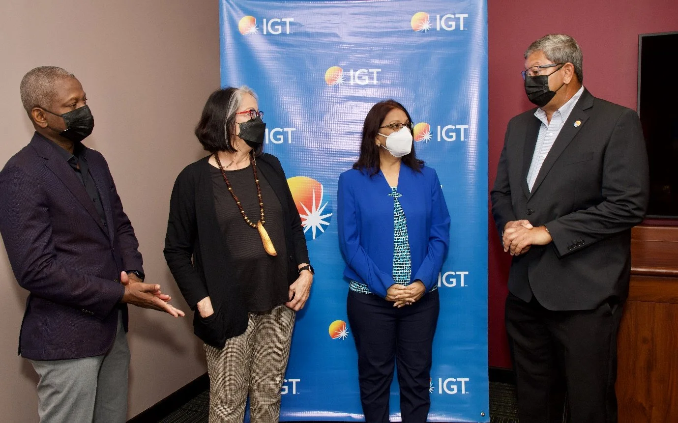 (L-R) IGT Deputy Country Manager Dexter W Thomas, Cotton Tree Foundation Chairperson Allyson Hamel-Smith, Cotton Tree Foundation Executive Director Sita Persad and IGT Country Manager Roger Bolai share light conversation during the brief handover for the IGT-donated technology equipment to outfit the Cotton Tree Foundation computer room.