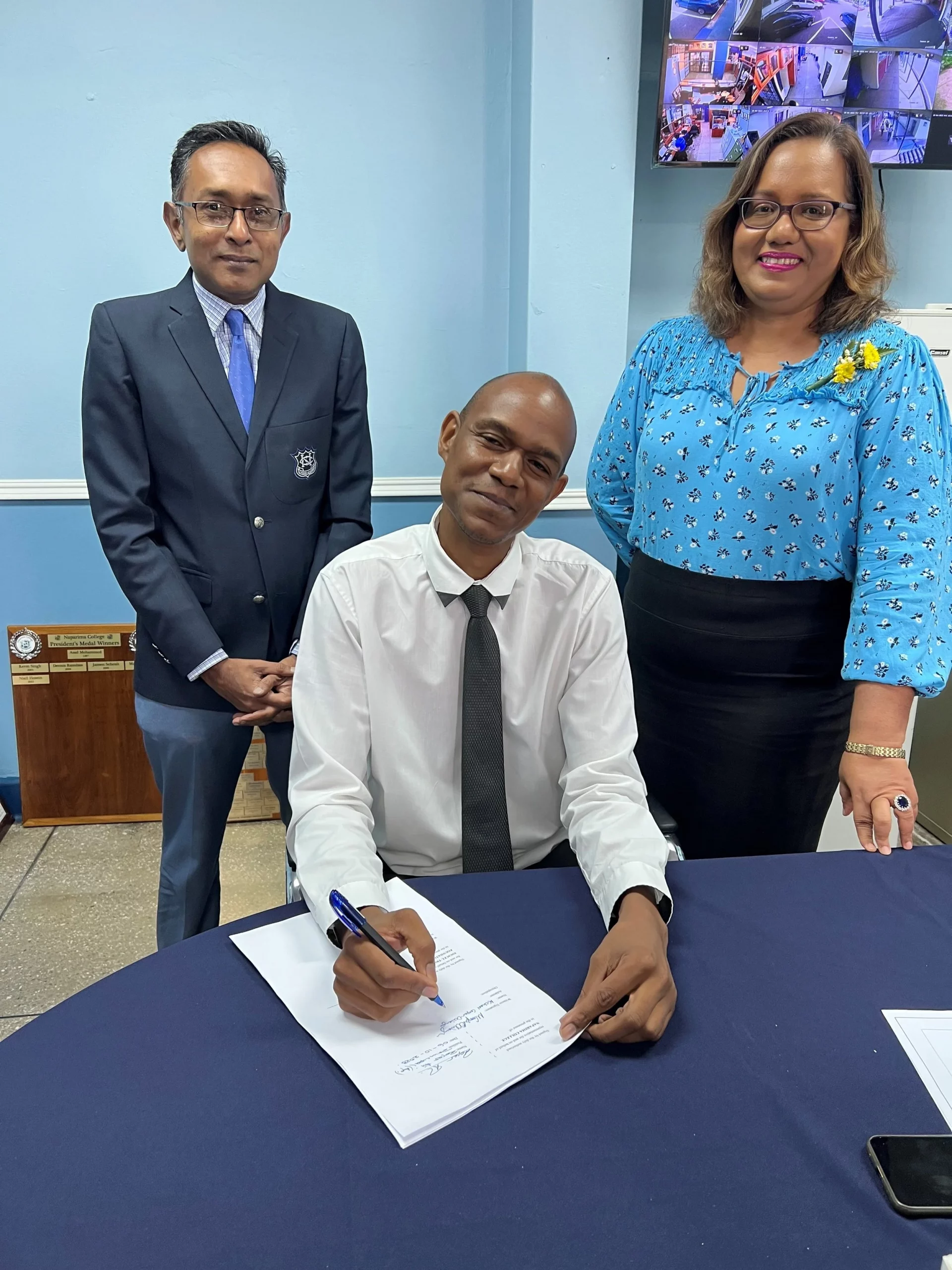  (L-R) Mr. Roger Ali, Naparima College Principal (Ag), Mr. Michael Cooper-Ochiengh and Ms. Hema Jaggernauth, the school’s Communications Manager, at the signing of the 2023 EPIC programme contract.   
