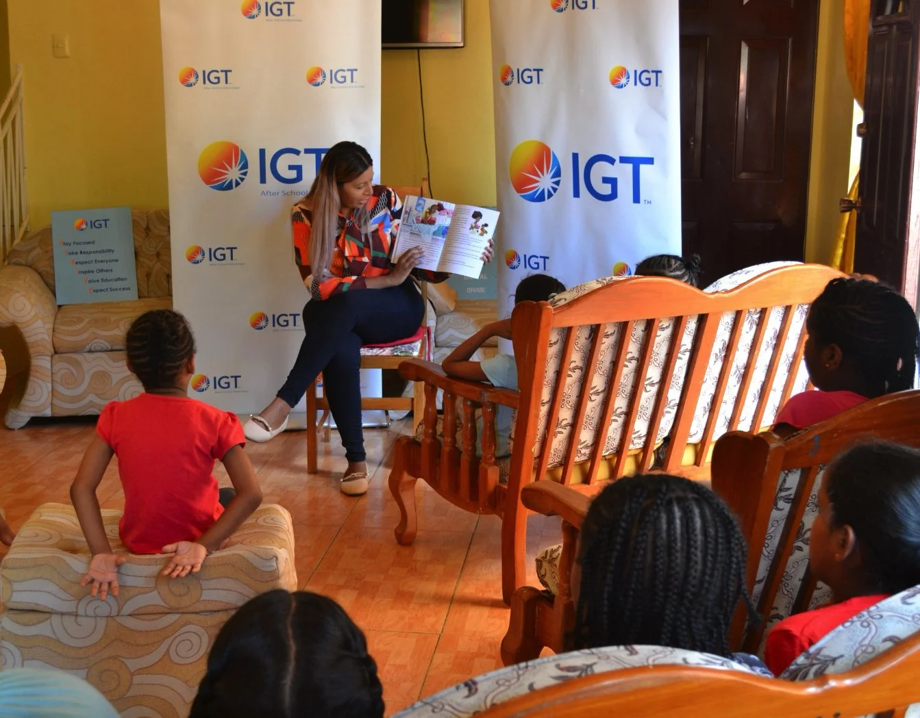 IGT employee Raihaana Mohammed spreads the love of reading with children of Amica House on October 13, 2023.