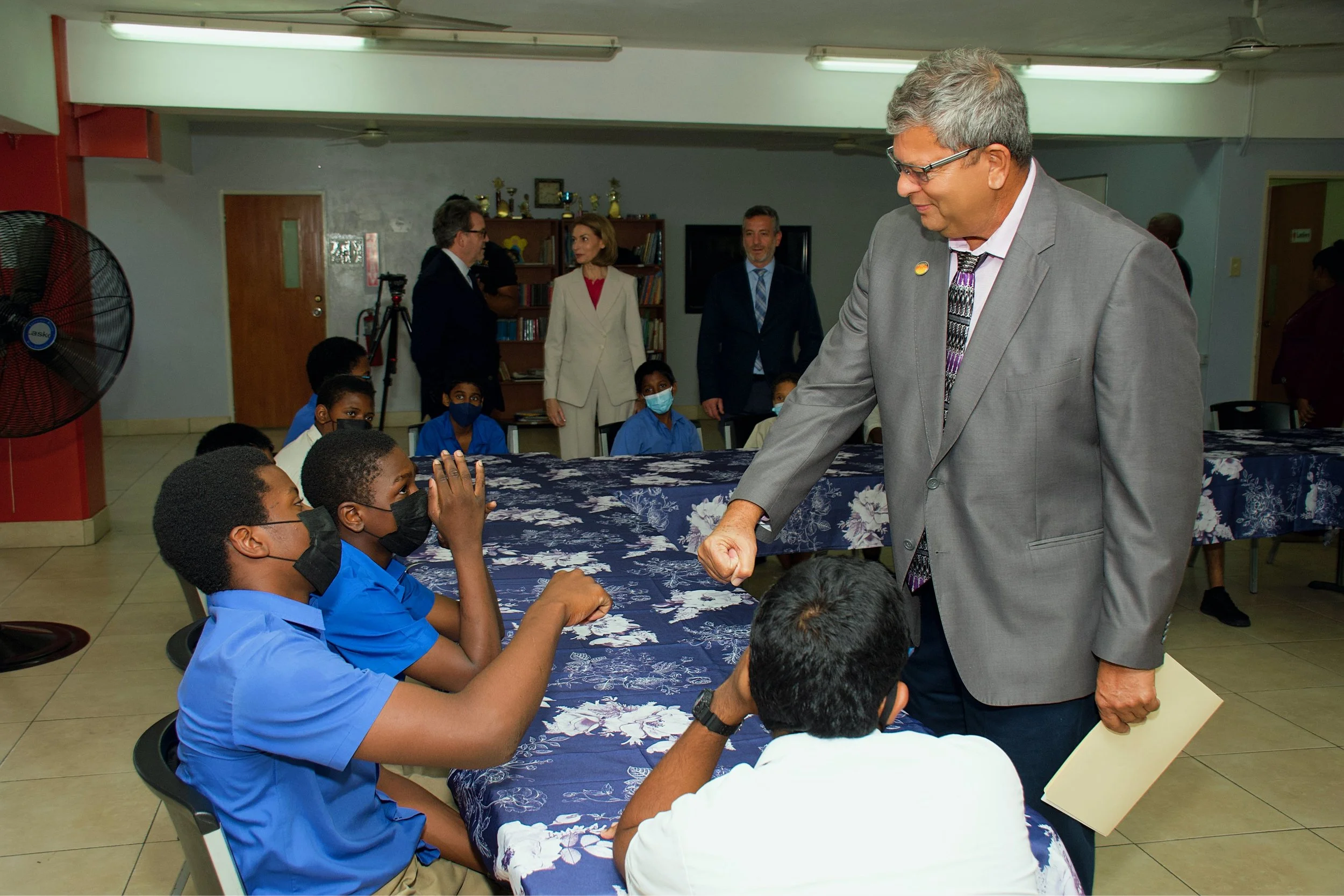 IGT Country Manager Roger Bolai engages with children at the Credo Boys Home on Nelson Street, East Port of Spain.
